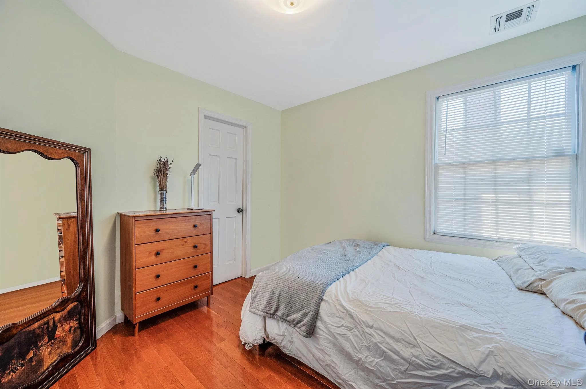 Bedroom featuring wood finished floors and baseboards Bedroom featuring wood finished floors and baseboards