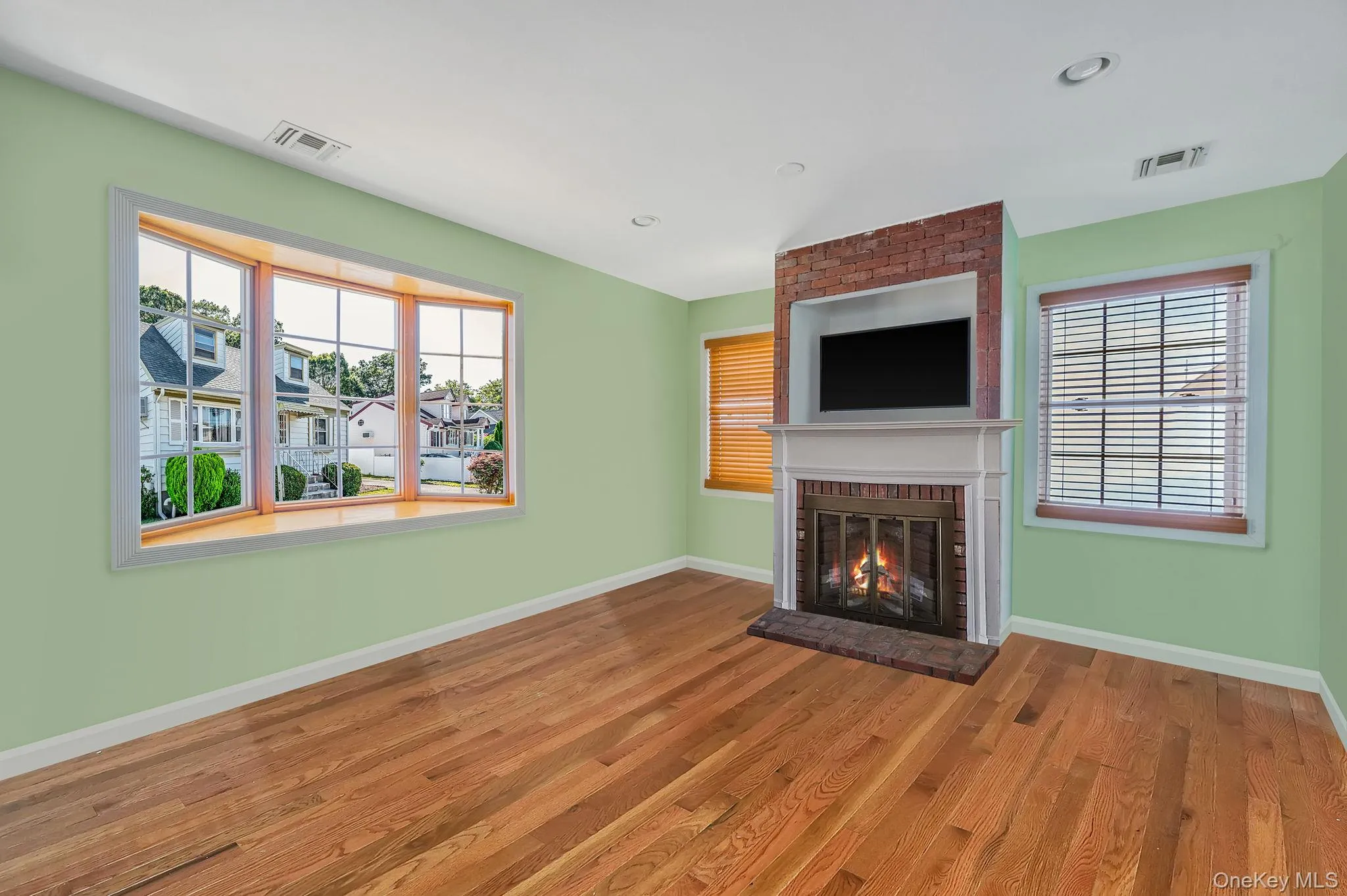 Unfurnished living room with a fireplace, wood finished floors, and recessed lighting Unfurnished living room with a fireplace, wood finished floors, and recessed lighting