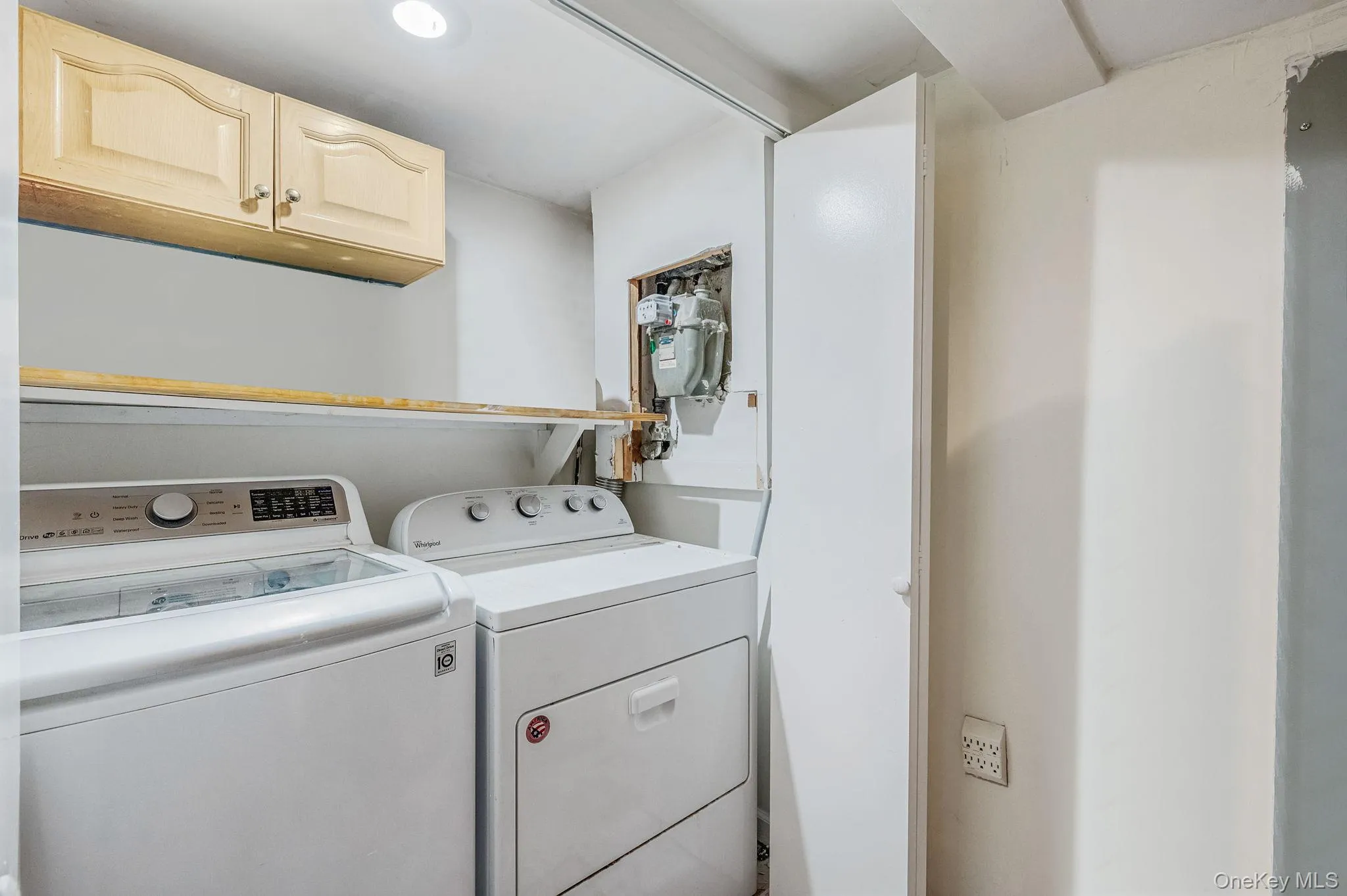 Laundry area with cabinet space, washing machine and dryer, and recessed lighting Laundry area with cabinet space, washing machine and dryer, and recessed lighting