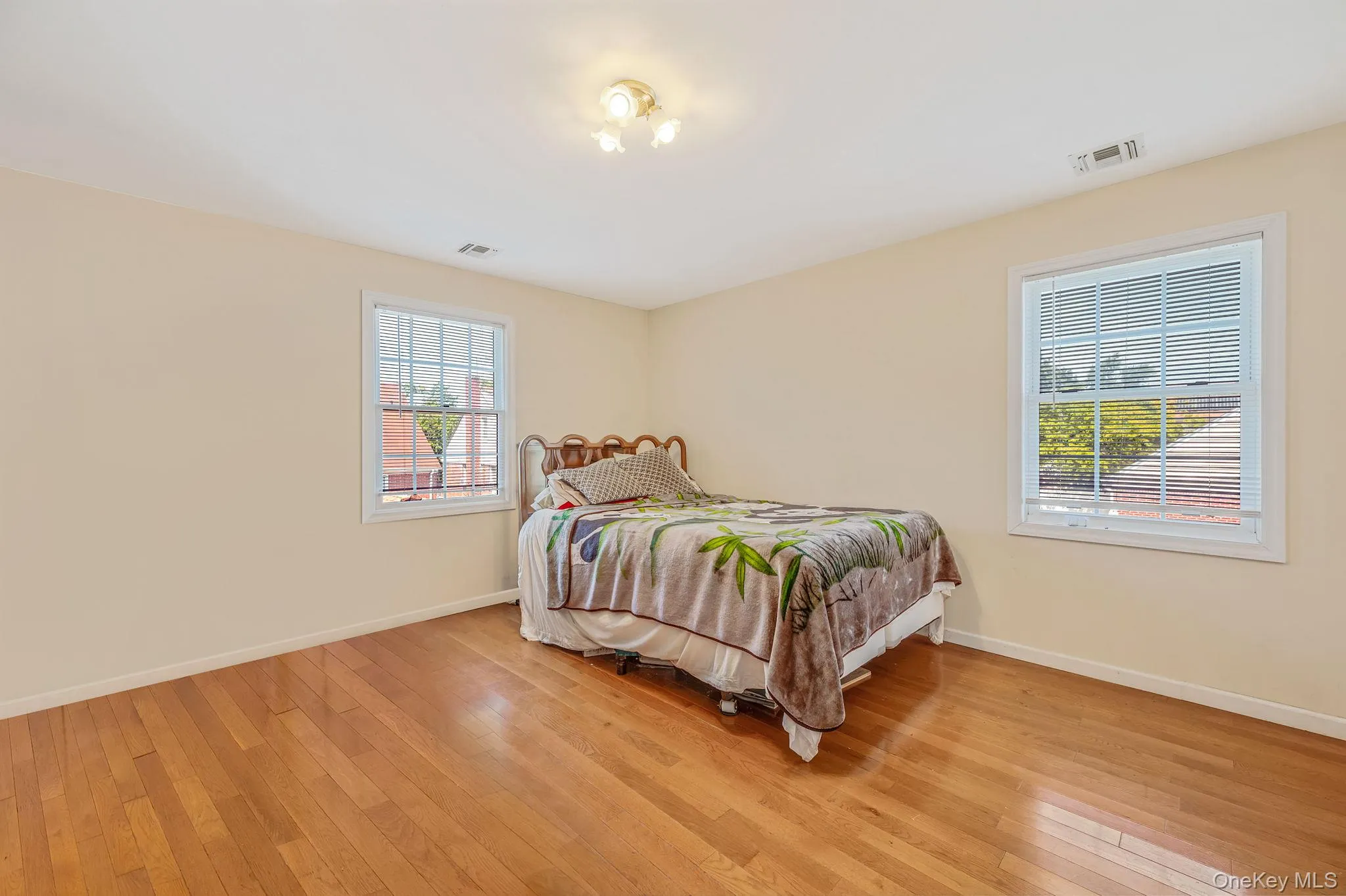 Bedroom featuring light wood finished floors Bedroom featuring light wood finished floors