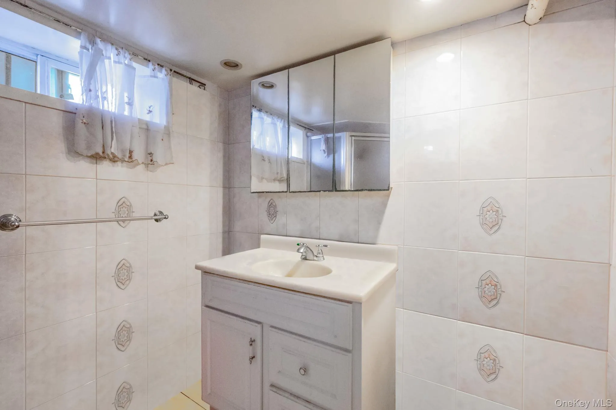 Bathroom with tile walls and vanity Bathroom with tile walls and vanity