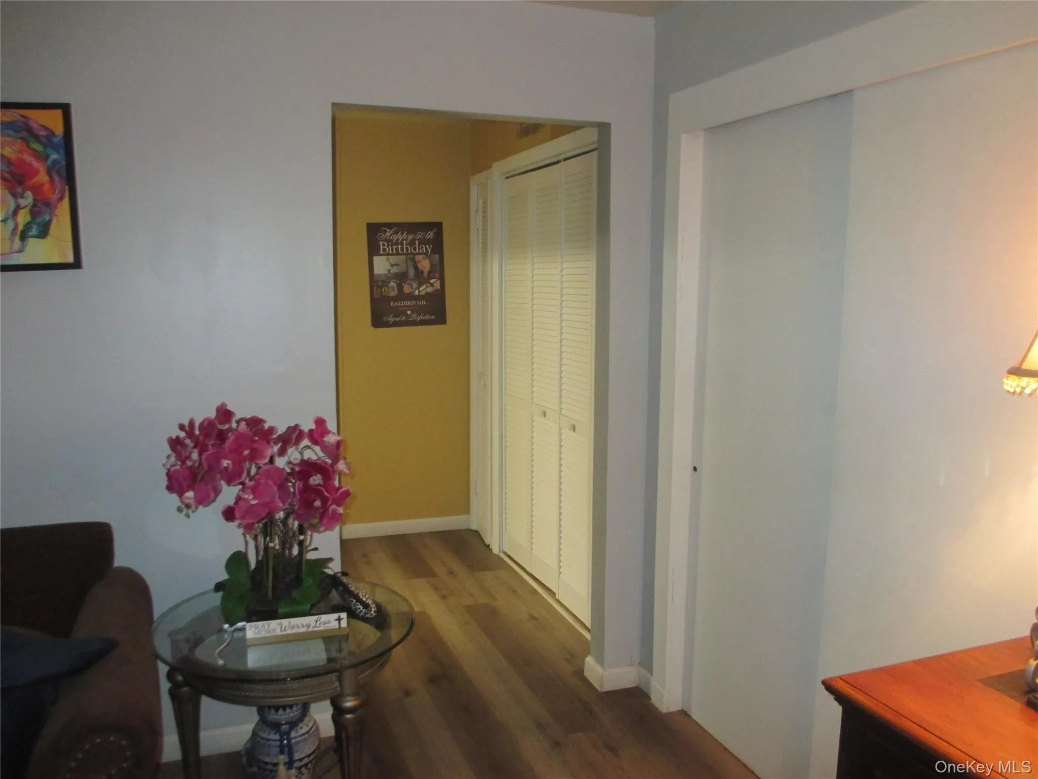Hallway featuring dark wood finished floors and baseboards Hallway featuring dark wood finished floors and baseboards