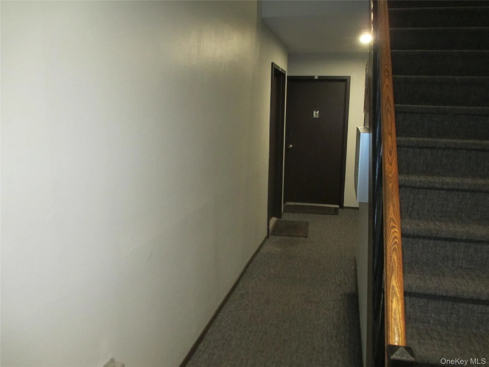 Corridor featuring stairs and carpet floors Corridor featuring stairs and carpet floors