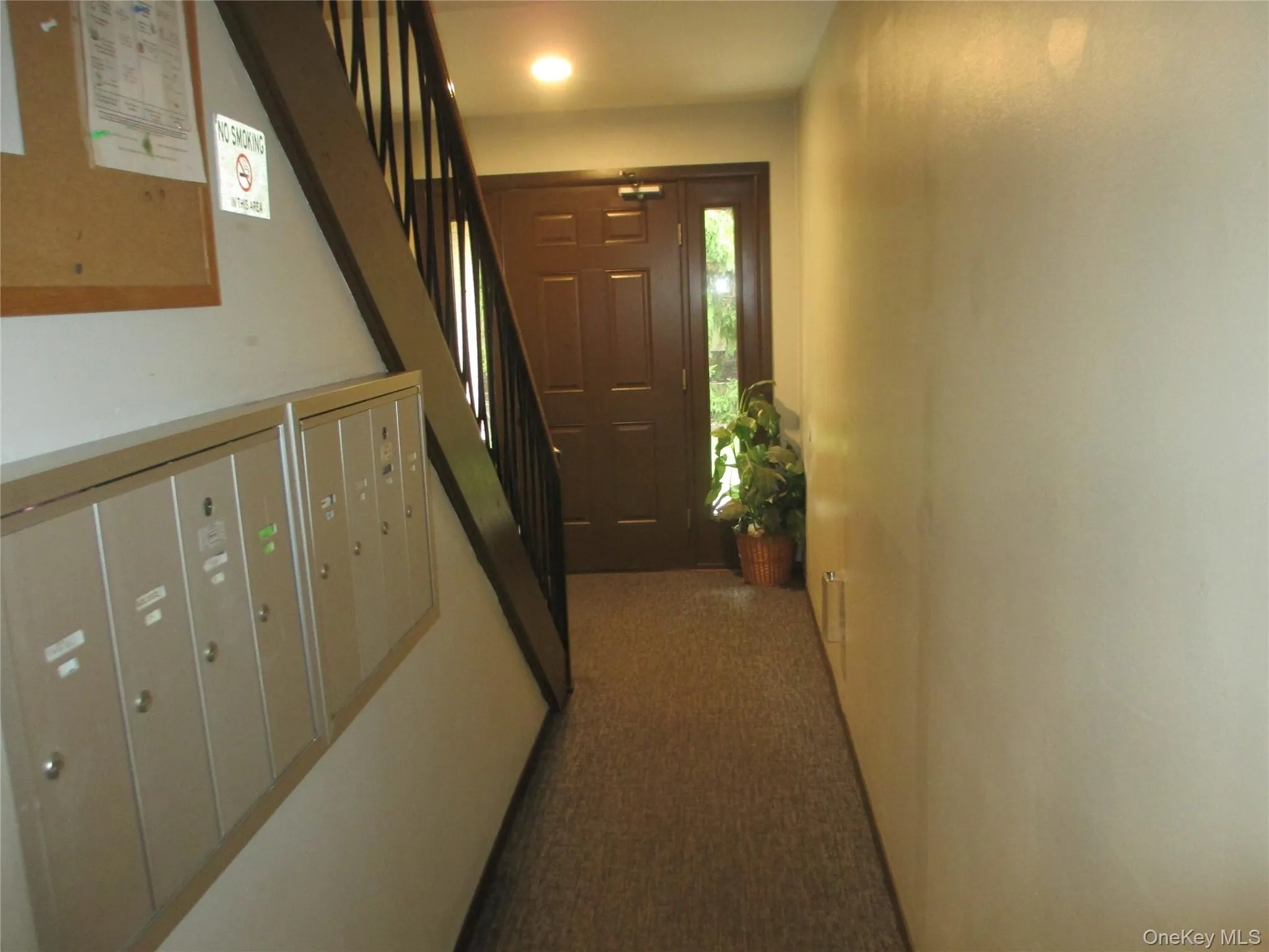 Hall featuring carpet and mail area Hall featuring carpet and mail area