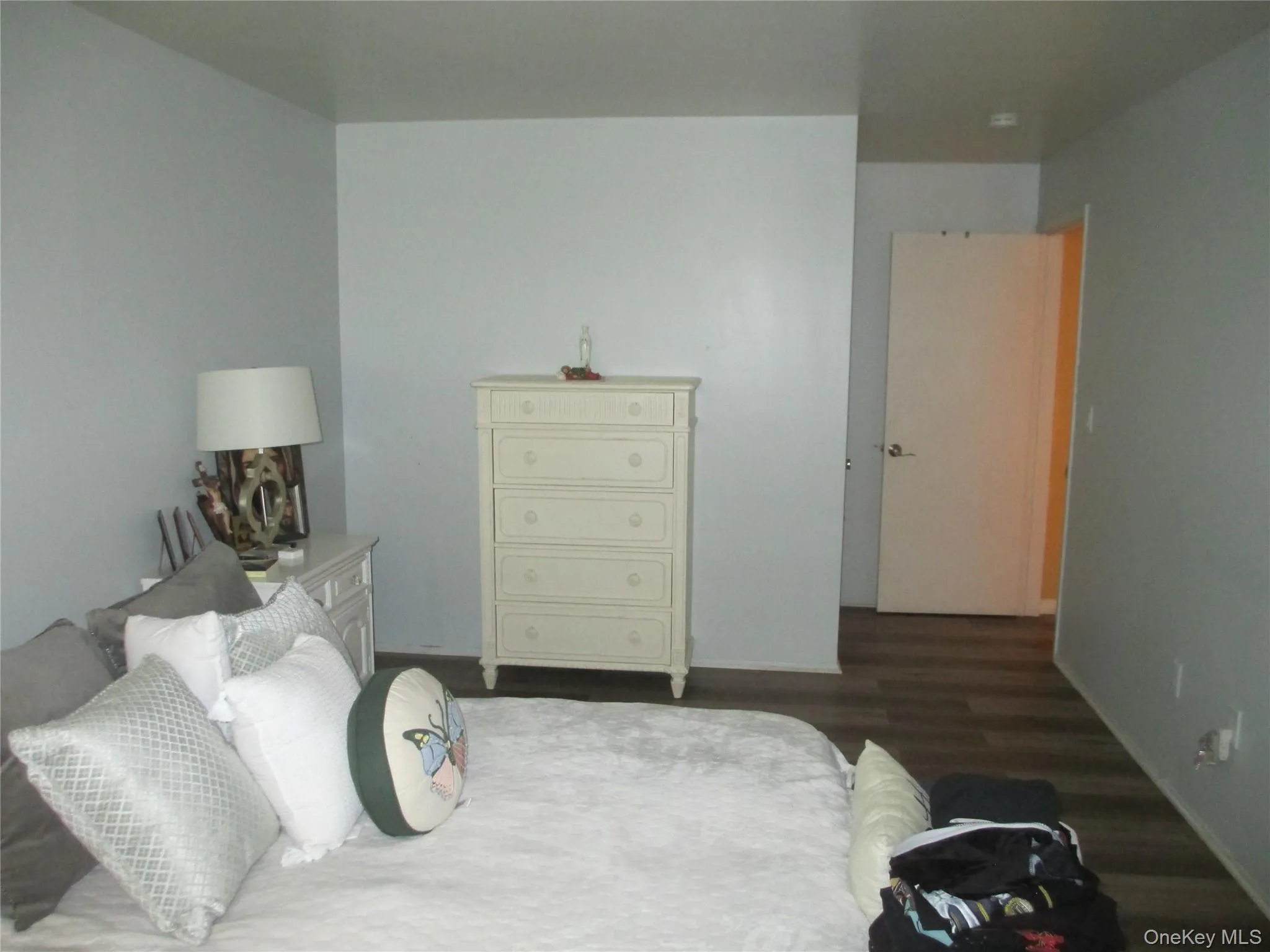 Bedroom featuring wood finished floors and baseboards Bedroom featuring wood finished floors and baseboards