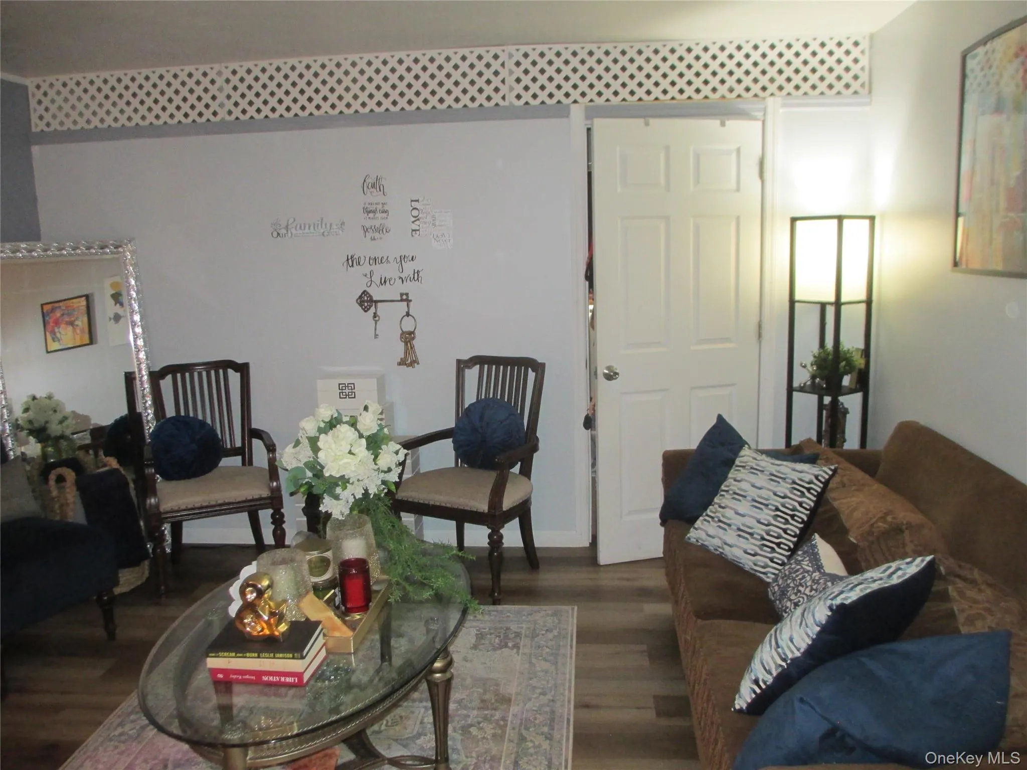 Living area featuring dark wood-style flooring and baseboards Living area featuring dark wood-style flooring and baseboards