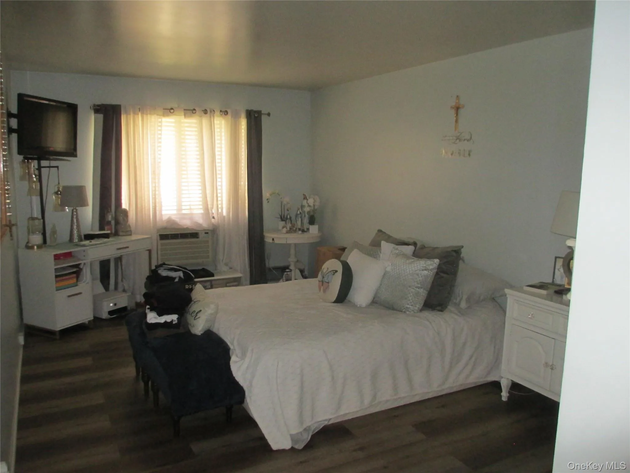 Bedroom with dark wood finished floors and cooling unit Bedroom with dark wood finished floors and cooling unit