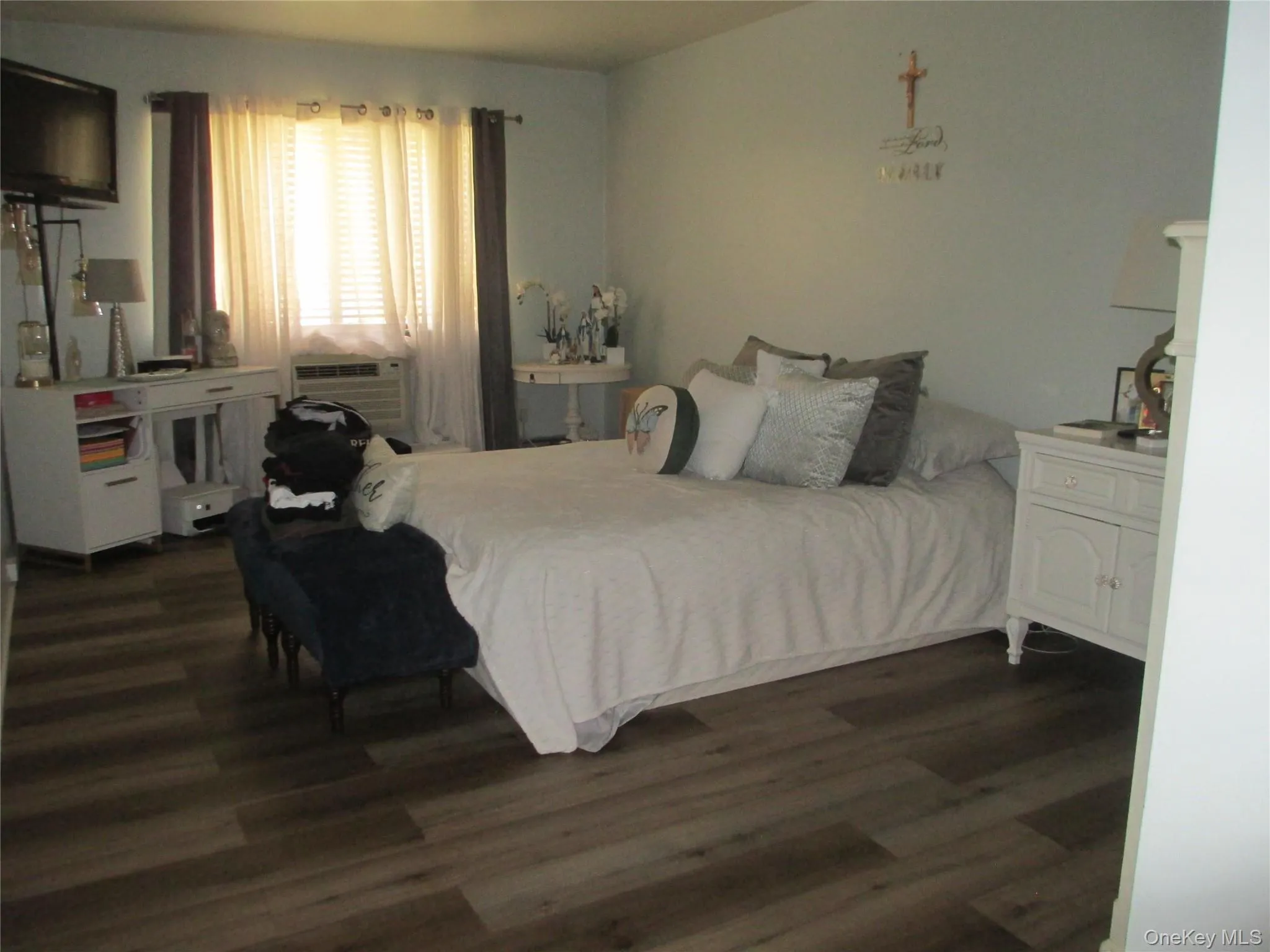 Bedroom featuring dark wood-style flooring and cooling unit Bedroom featuring dark wood-style flooring and cooling unit