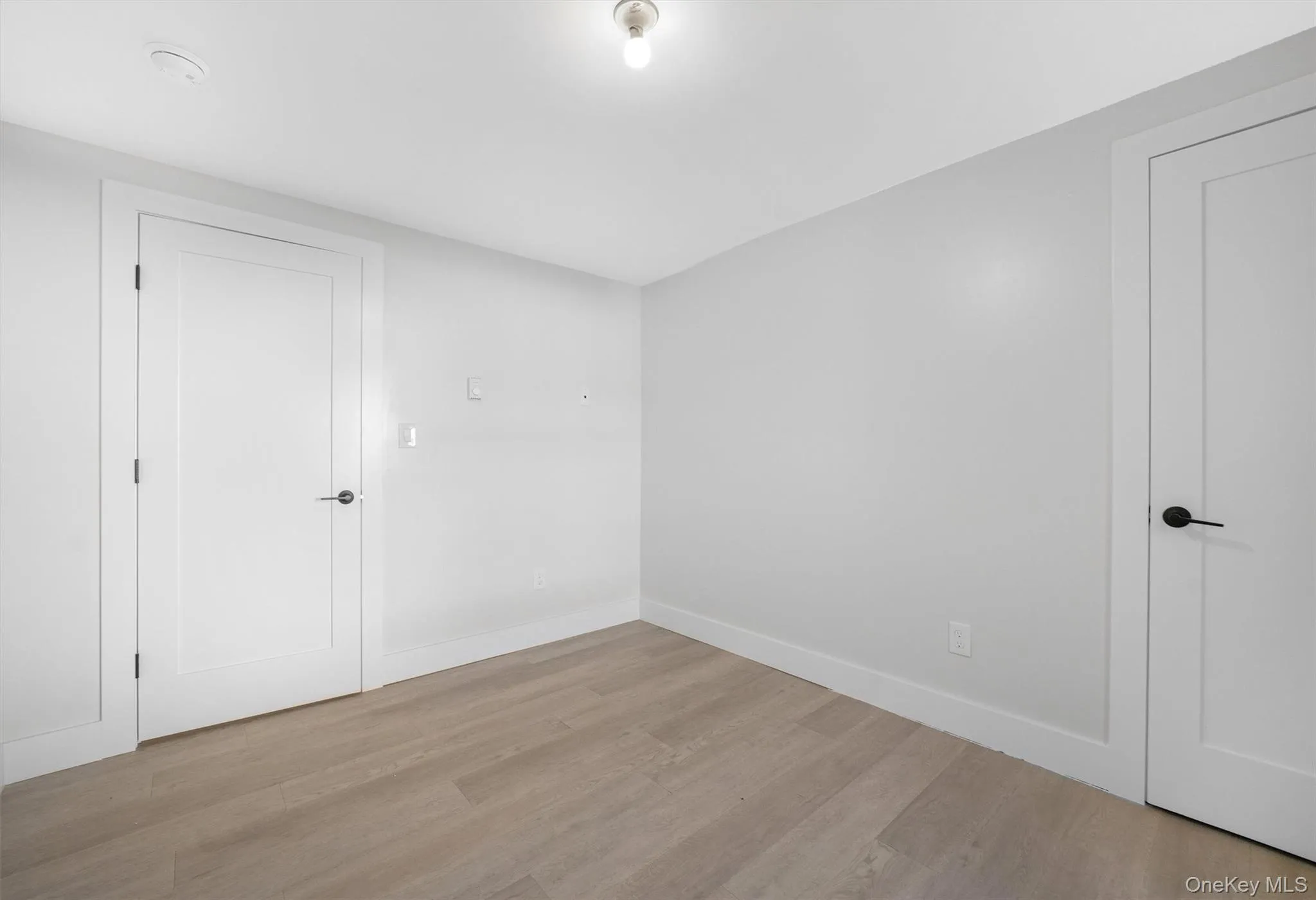 Empty room with baseboards and wood finished floors Empty room with baseboards and wood finished floors