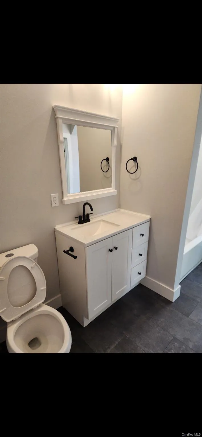 Bathroom with vanity and baseboards Bathroom with vanity and baseboards