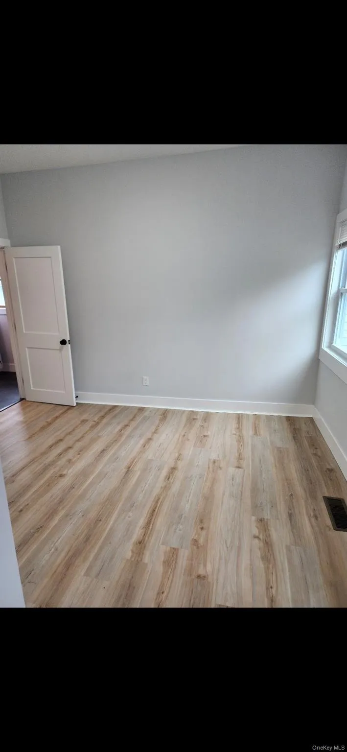 Primary room featuring plenty of natural light and light wood finished floors Primary room featuring plenty of natural light and light wood finished floors