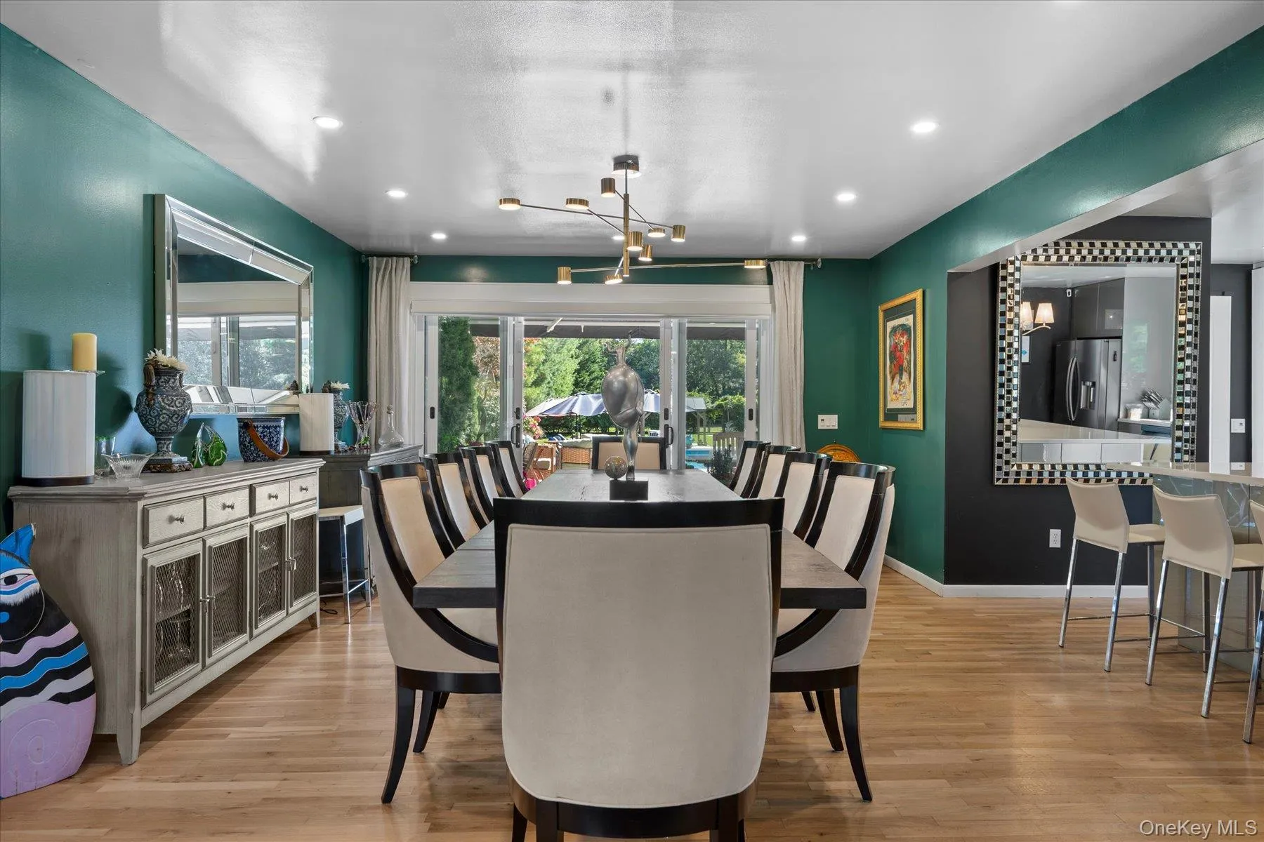 Dining space with light wood-style floors, recessed lighting, and a chandelier Dining space with light wood-style floors, recessed lighting, and a chandelier