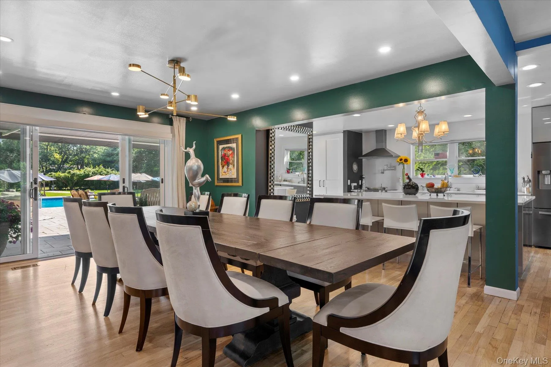Dining room with a chandelier, light wood finished floors, and recessed lighting Dining room with a chandelier, light wood finished floors, and recessed lighting