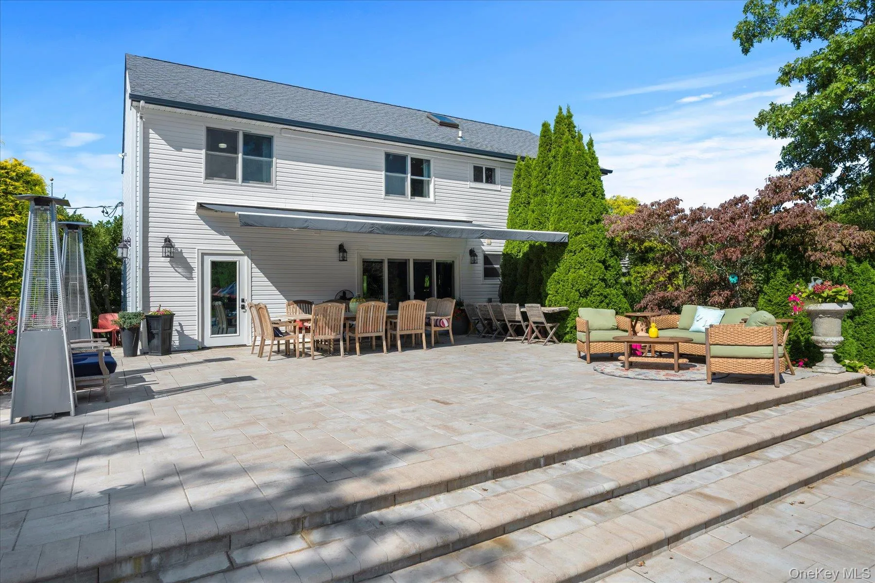 Back of house with a patio, an outdoor hangout area, and a shingled roof Back of house with a patio, an outdoor hangout area, and a shingled roof