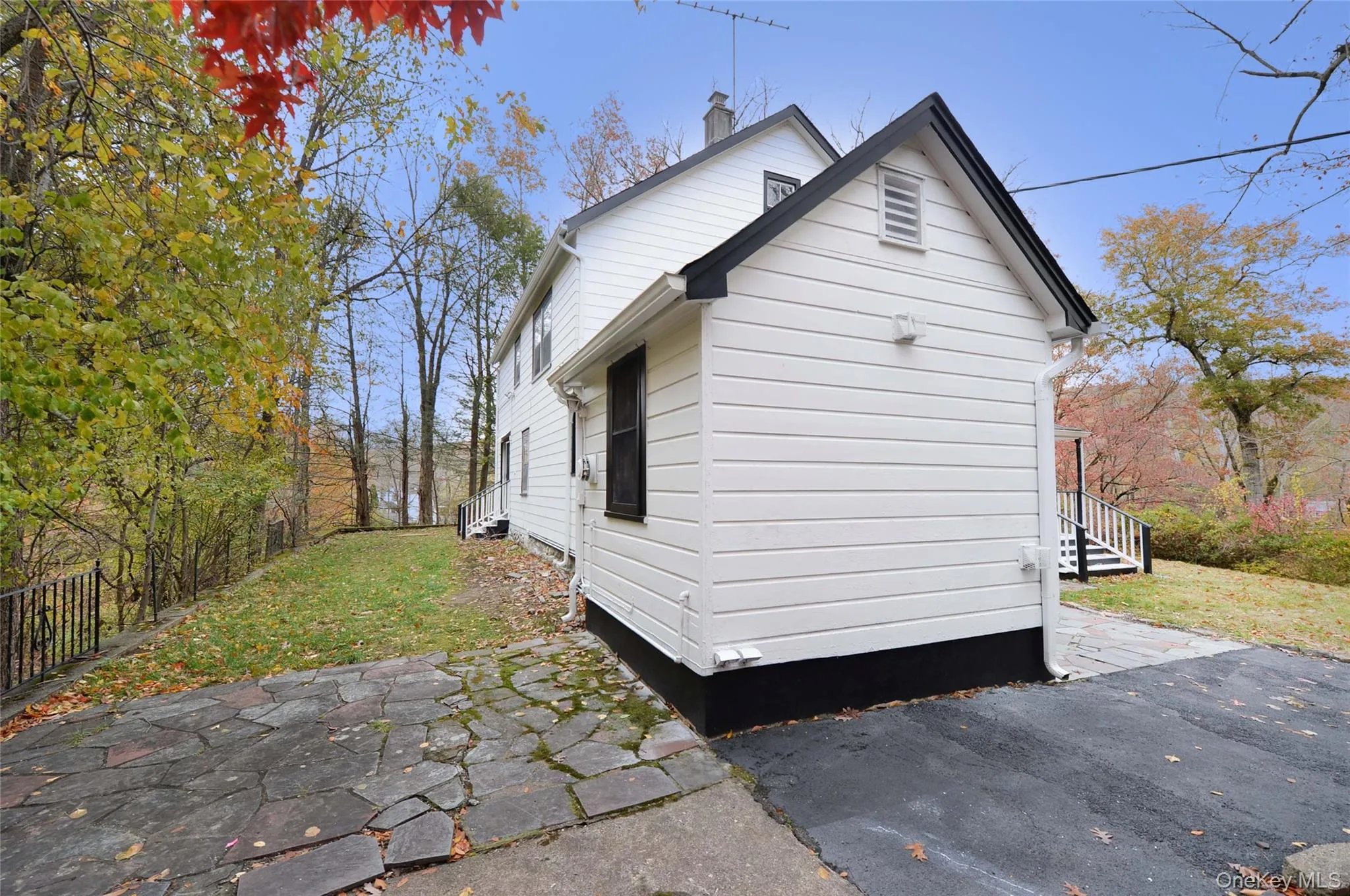 View of property exterior featuring a chimney and a patio View of property exterior featuring a chimney and a patio