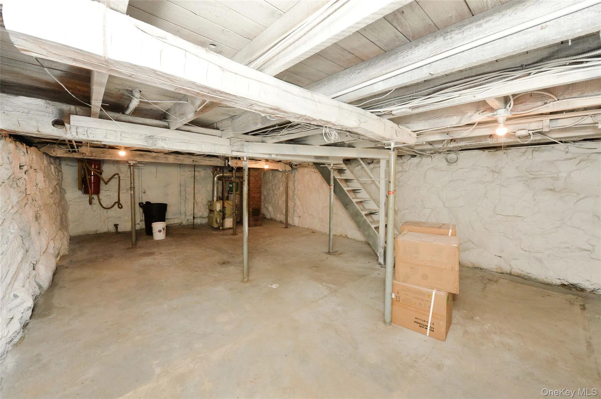 Unfinished basement featuring stairs Unfinished basement featuring stairs