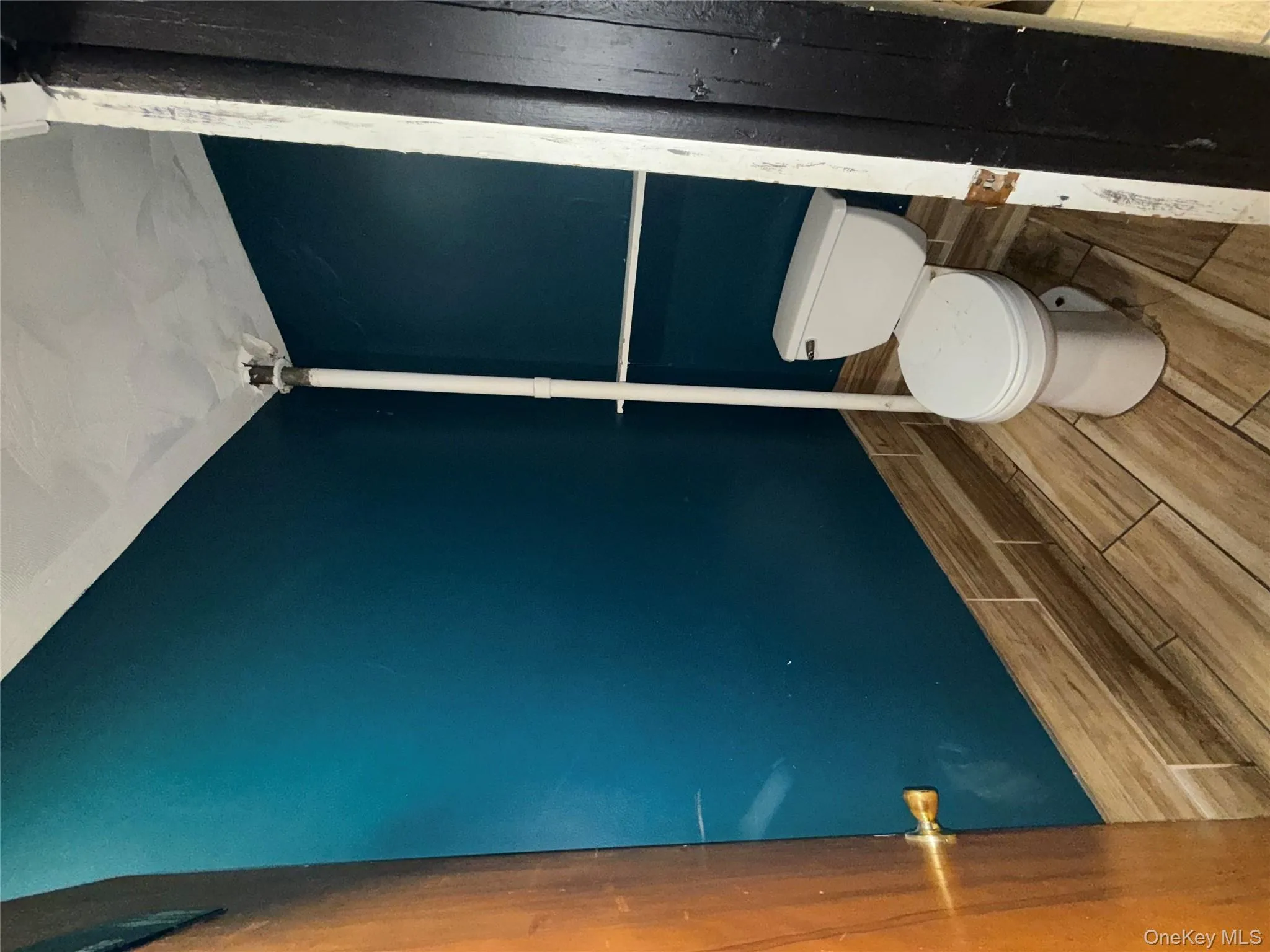 Half bath featuring wood finish floors and toilet Half bath featuring wood finish floors and toilet