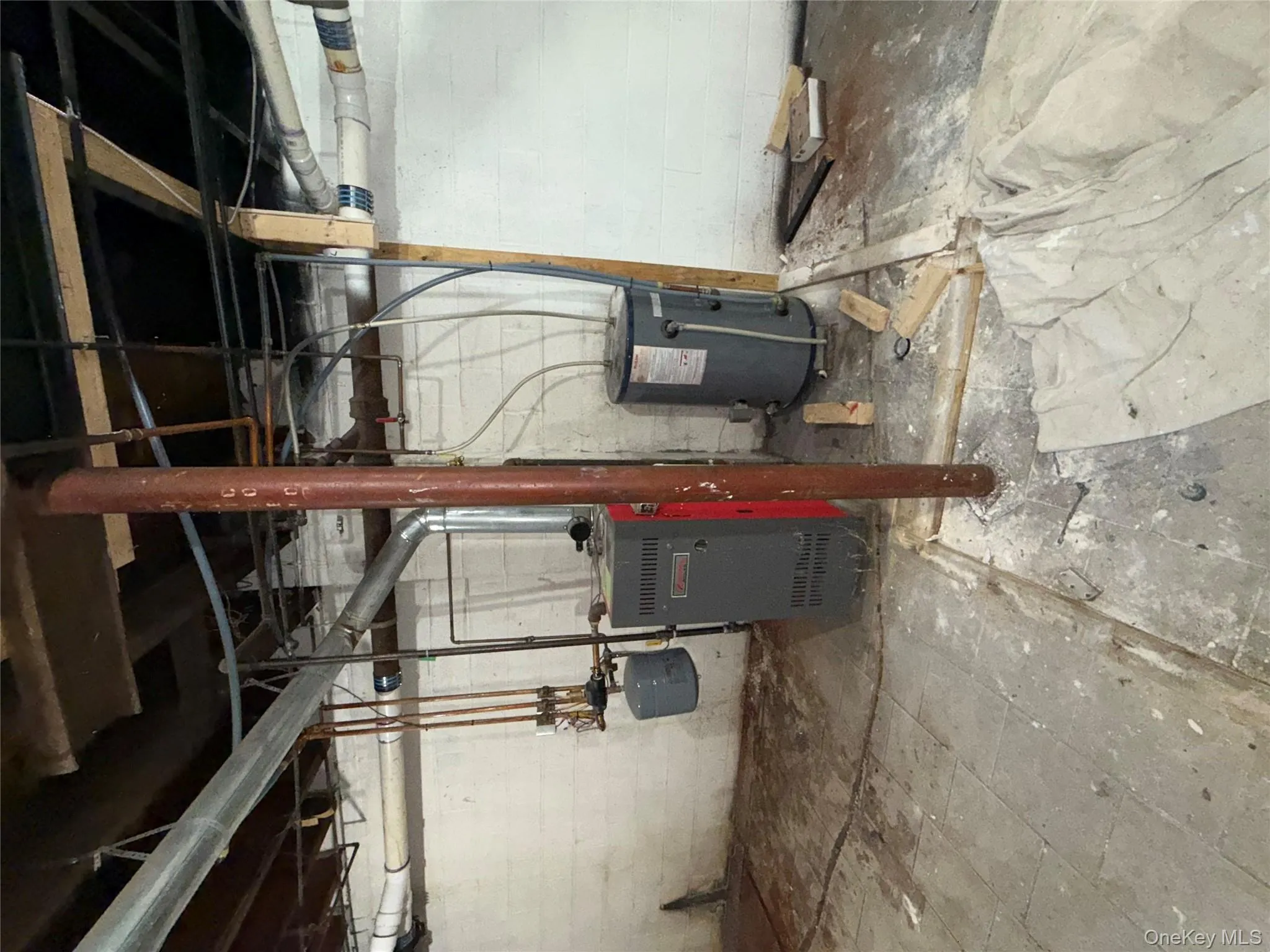 Unfinished basement with water heater and a heating unit Unfinished basement with water heater and a heating unit