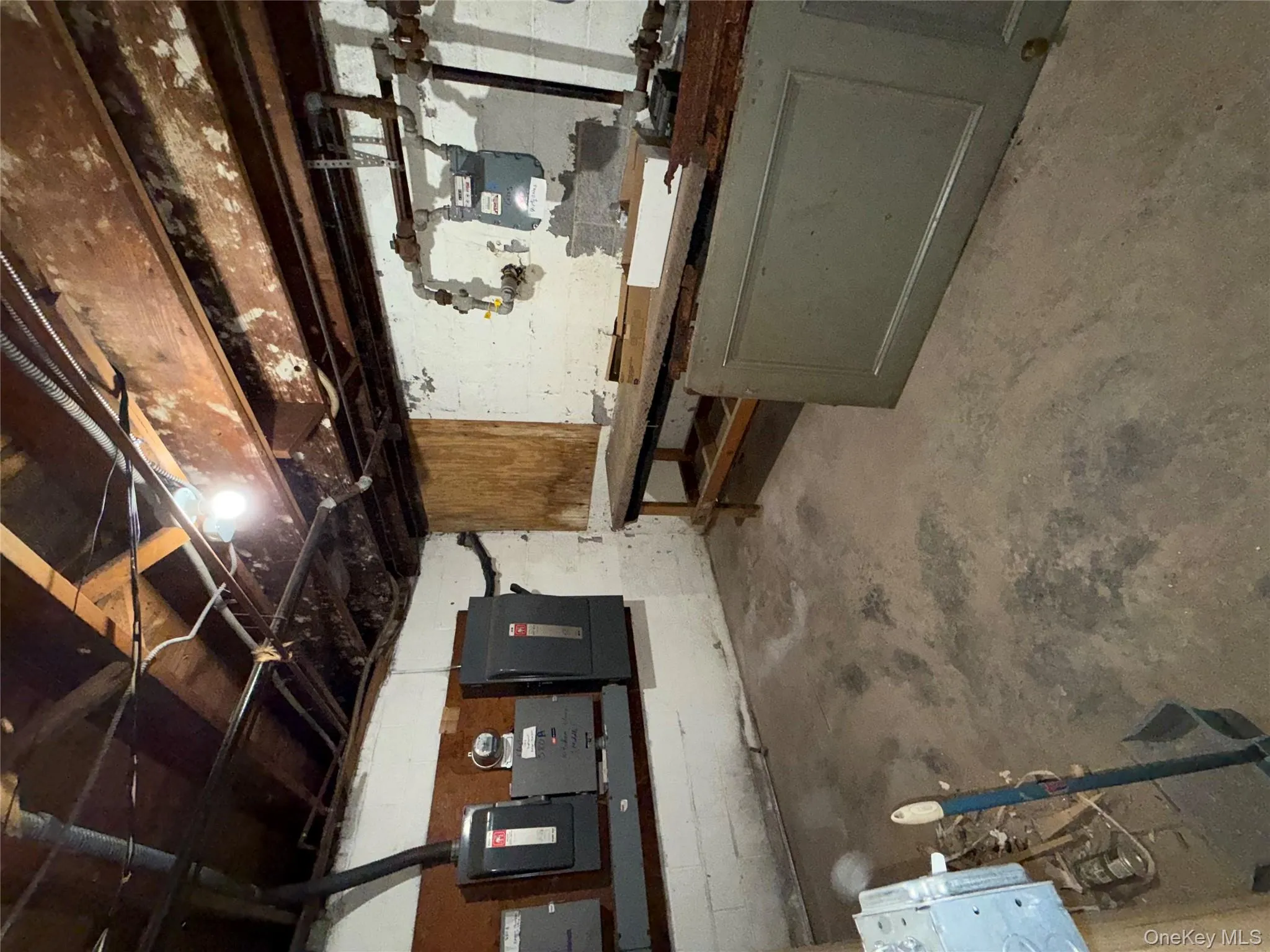 Unfinished basement with a workshop area and electric panel Unfinished basement with a workshop area and electric panel