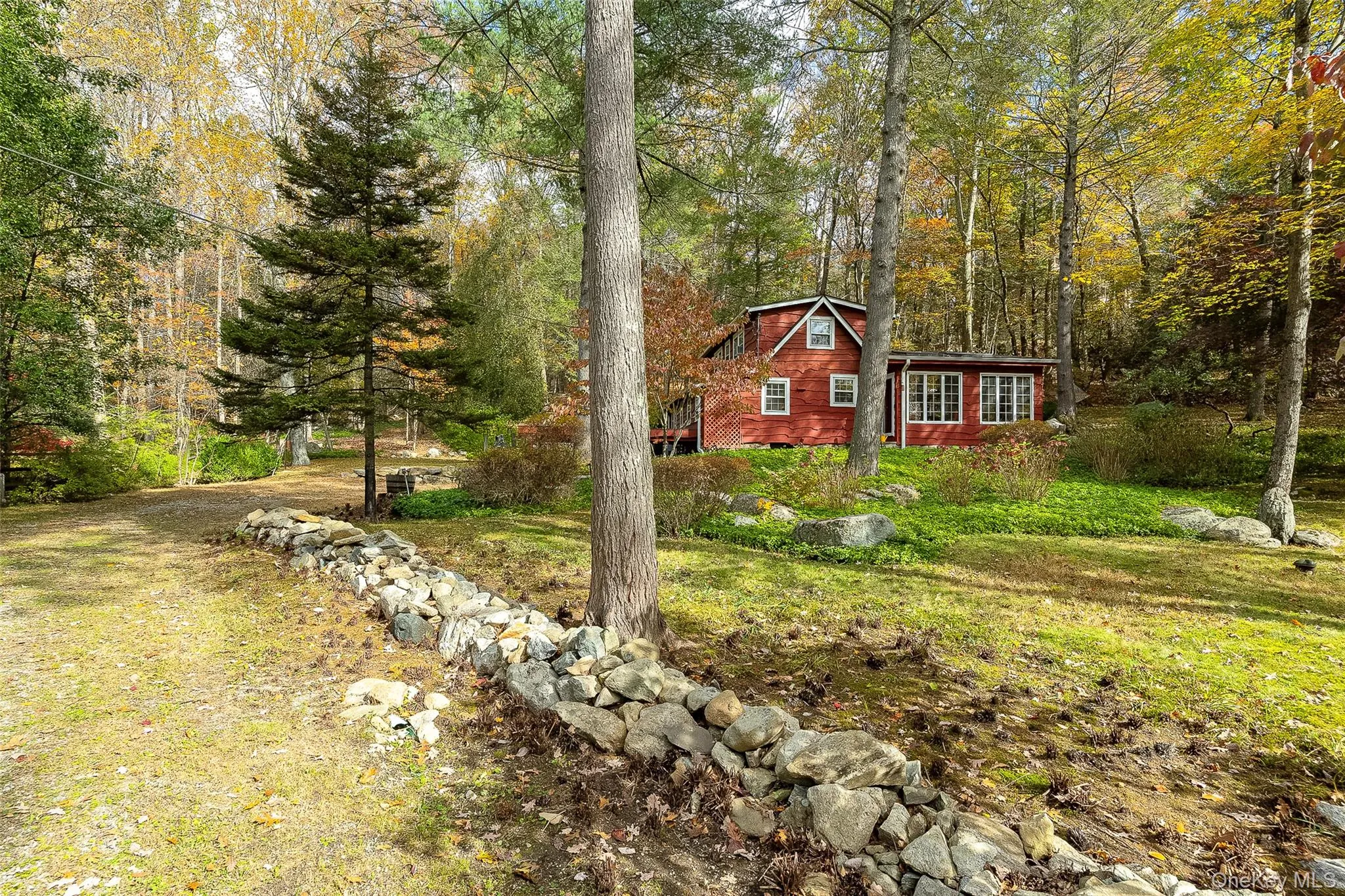 View of front of home featuring a view of trees View of front of home featuring a view of trees