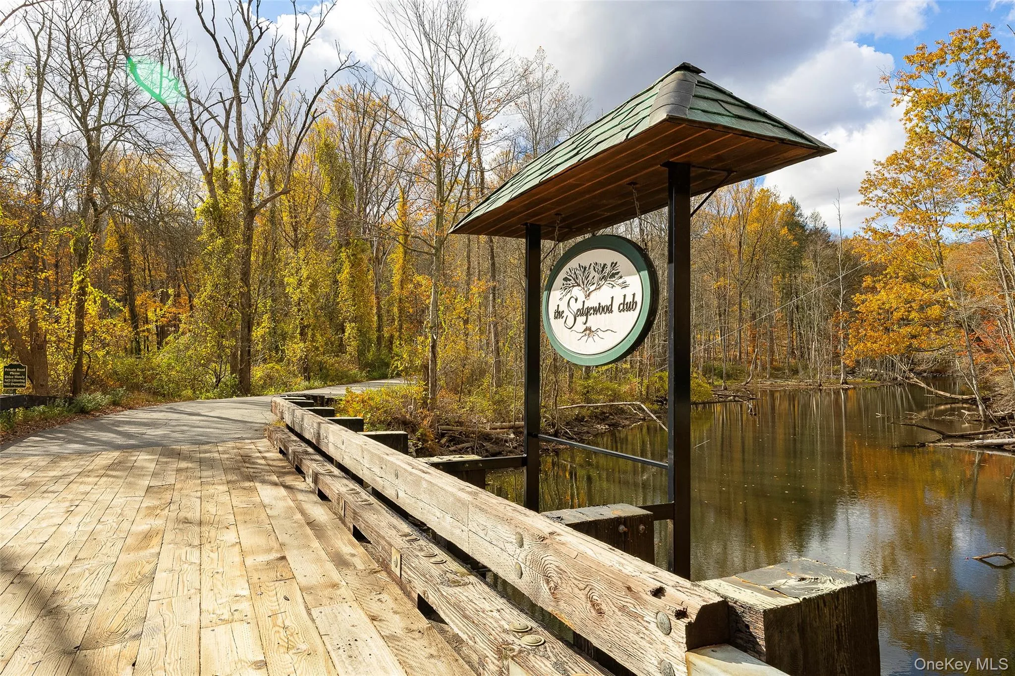 Dock featuring a water view and a forest view Dock featuring a water view and a forest view