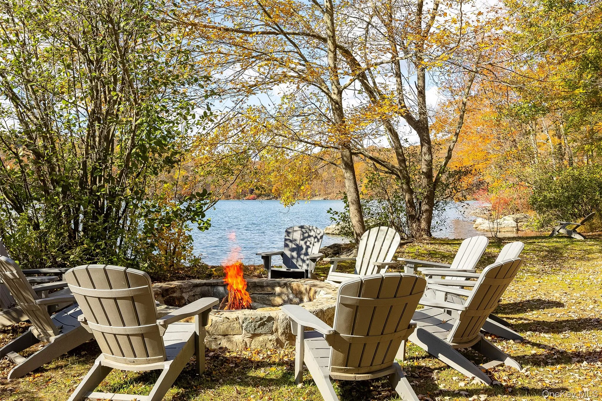 View of patio with an outdoor fire pit and a water view View of patio with an outdoor fire pit and a water view