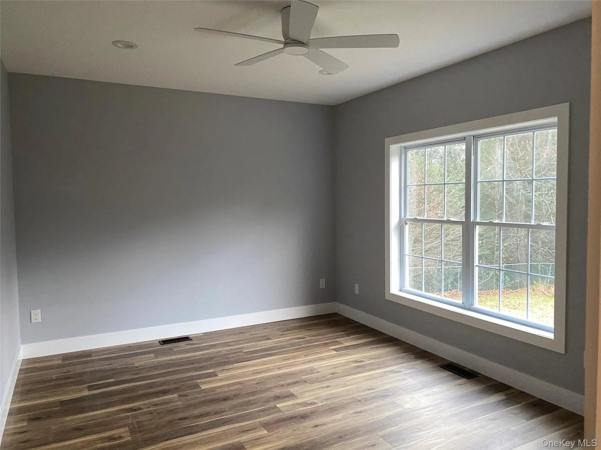 Spare room featuring light wood-style flooring and a ceiling fan Spare room featuring light wood-style flooring and a ceiling fan
