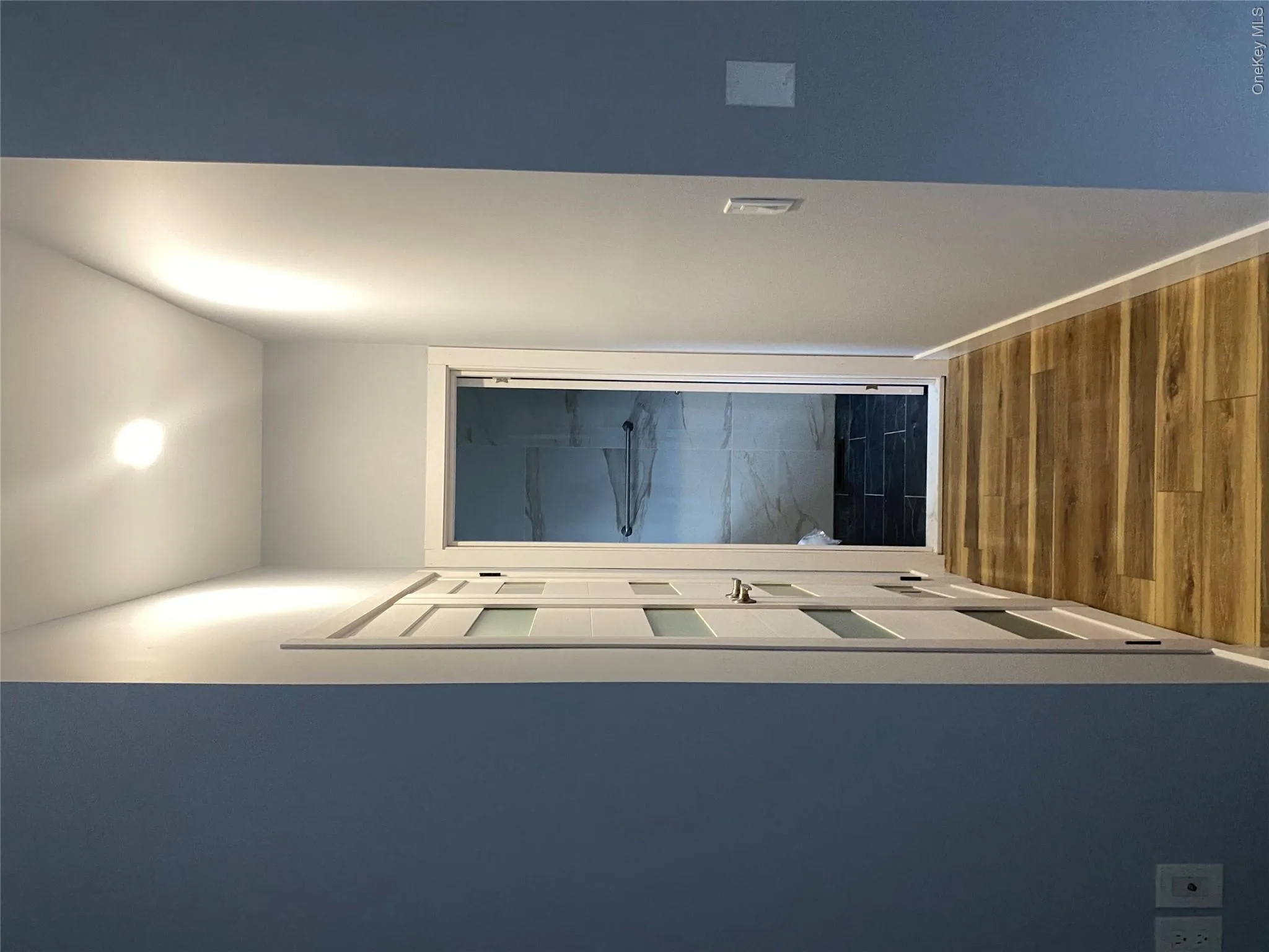 Corridor featuring dark wood-style flooring and baseboards Corridor featuring dark wood-style flooring and baseboards