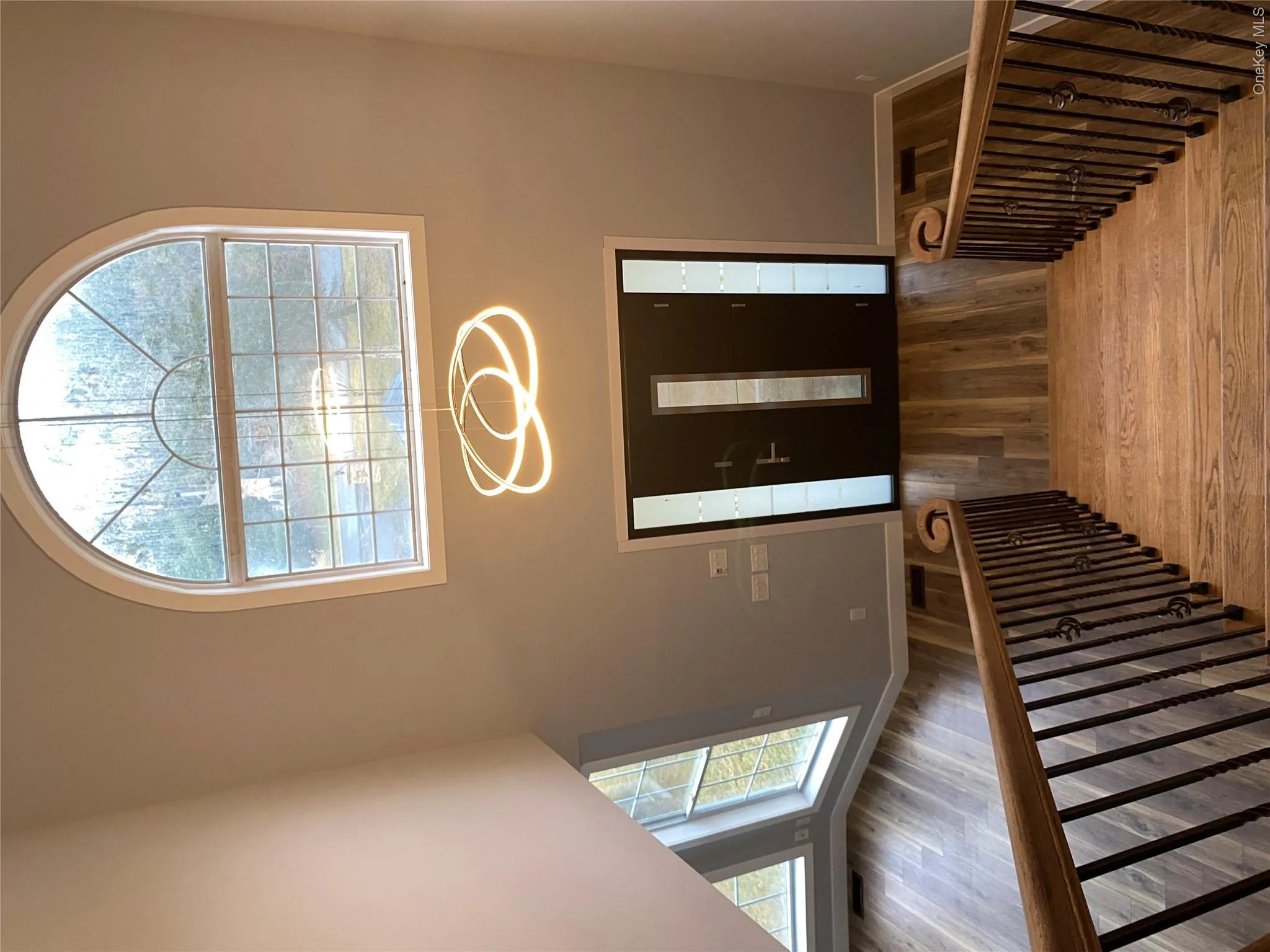 Entryway with wood finished floors and a high ceiling Entryway with wood finished floors and a high ceiling