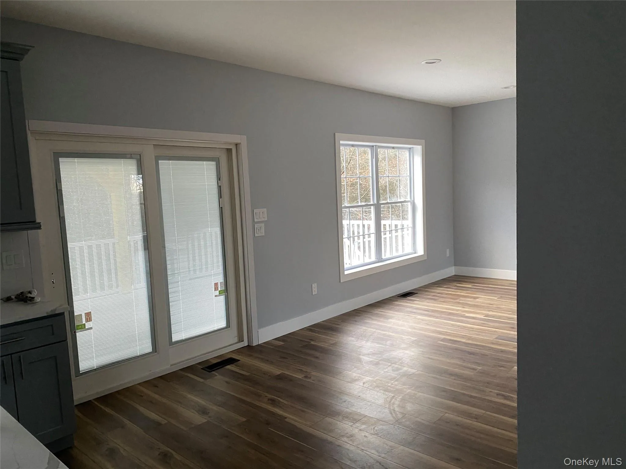 Unfurnished dining area featuring baseboards and dark wood-style flooring Unfurnished dining area featuring baseboards and dark wood-style flooring