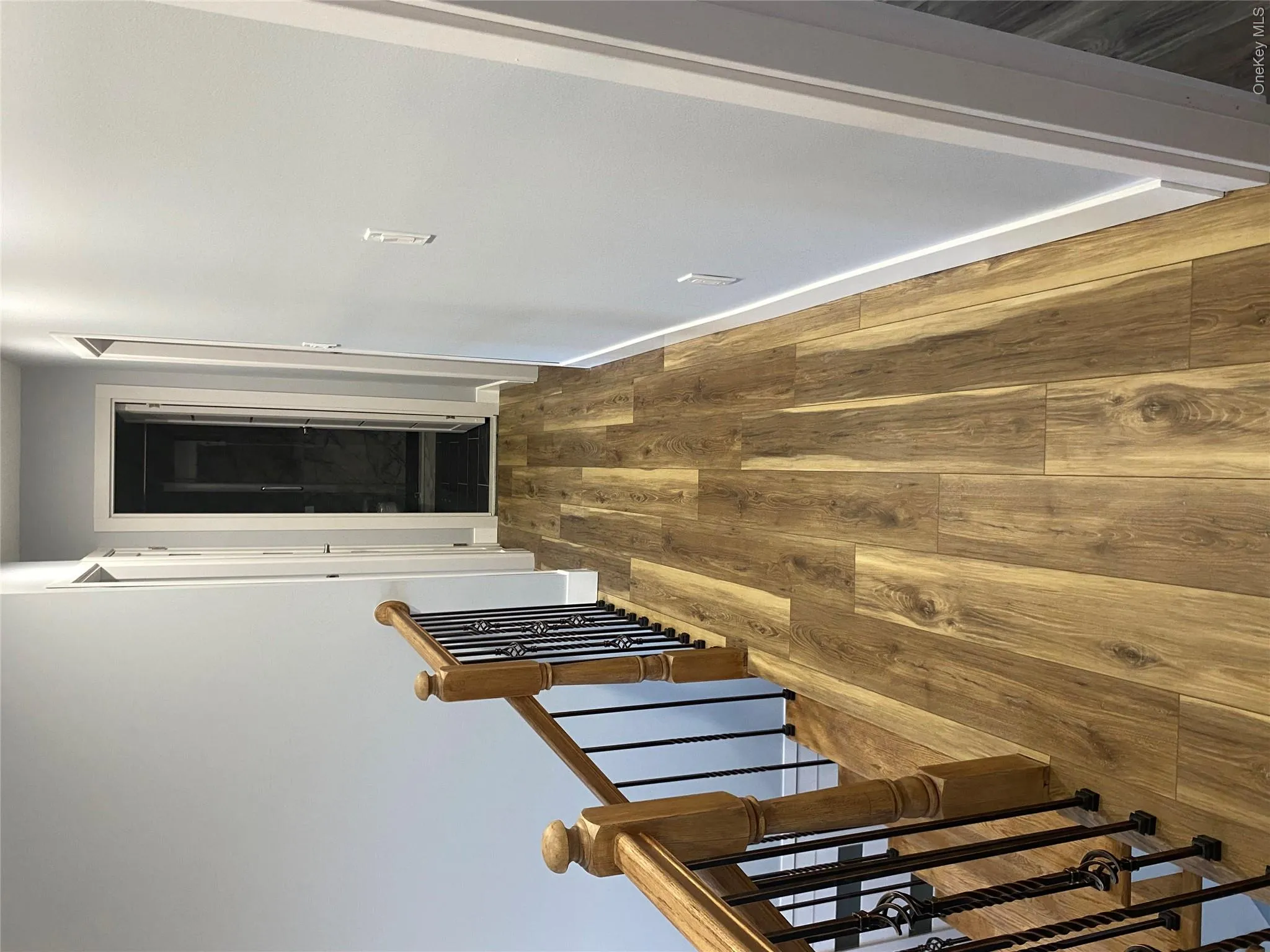 Corridor with dark wood-style floors and an upstairs landing Corridor with dark wood-style floors and an upstairs landing
