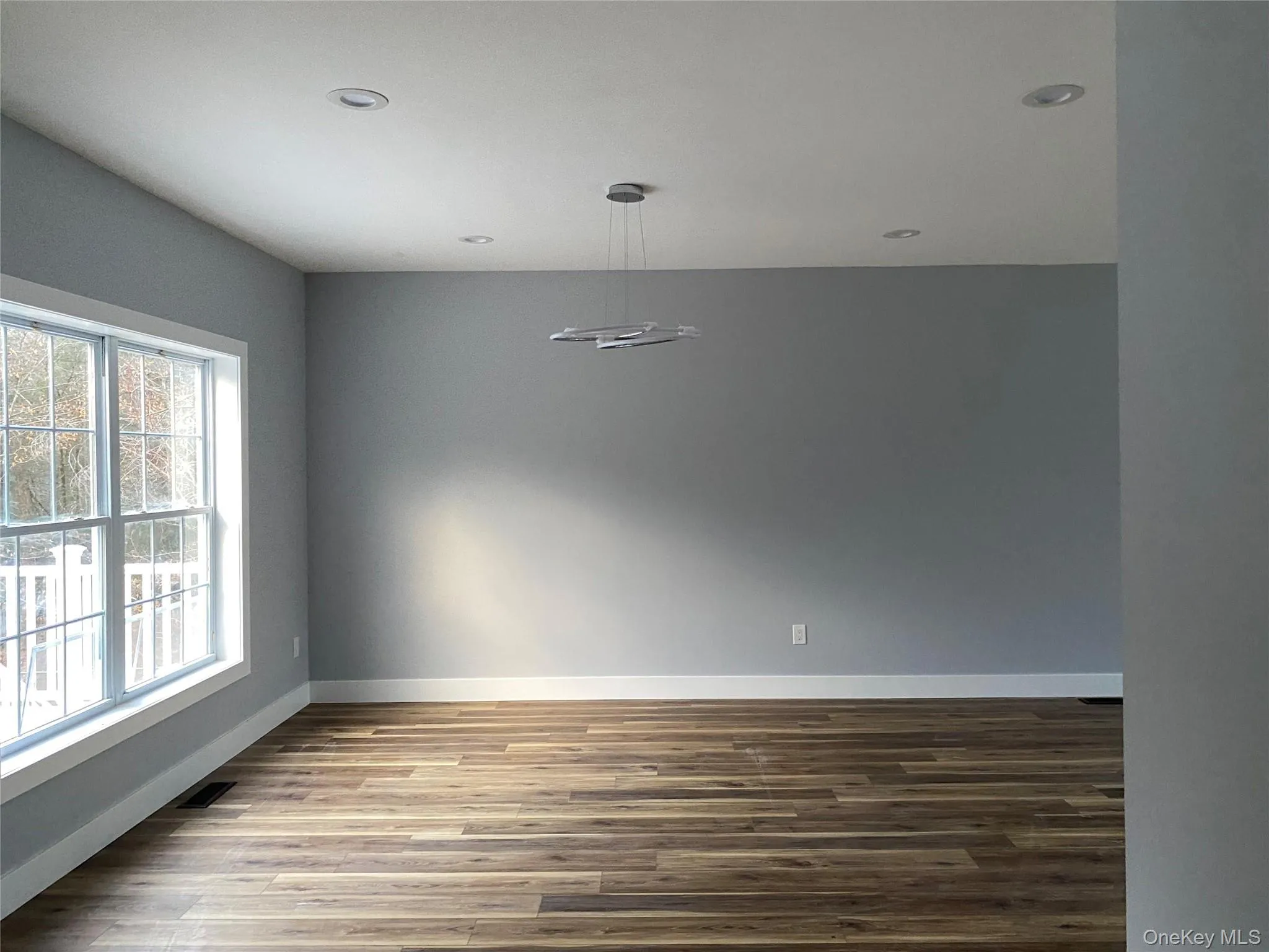 Unfurnished room featuring wood finished floors and recessed lighting Unfurnished room featuring wood finished floors and recessed lighting
