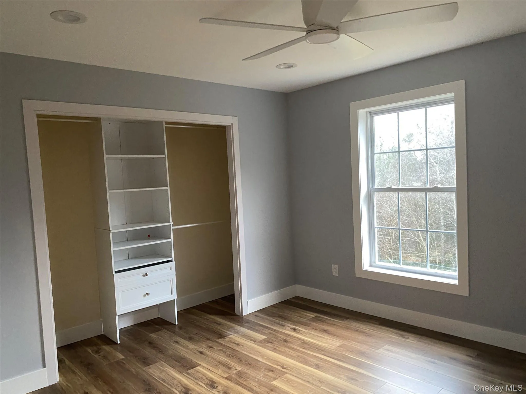 Unfurnished bedroom with light wood finished floors, ceiling fan, recessed lighting, and a closet Unfurnished bedroom with light wood finished floors, ceiling fan, recessed lighting, and a closet