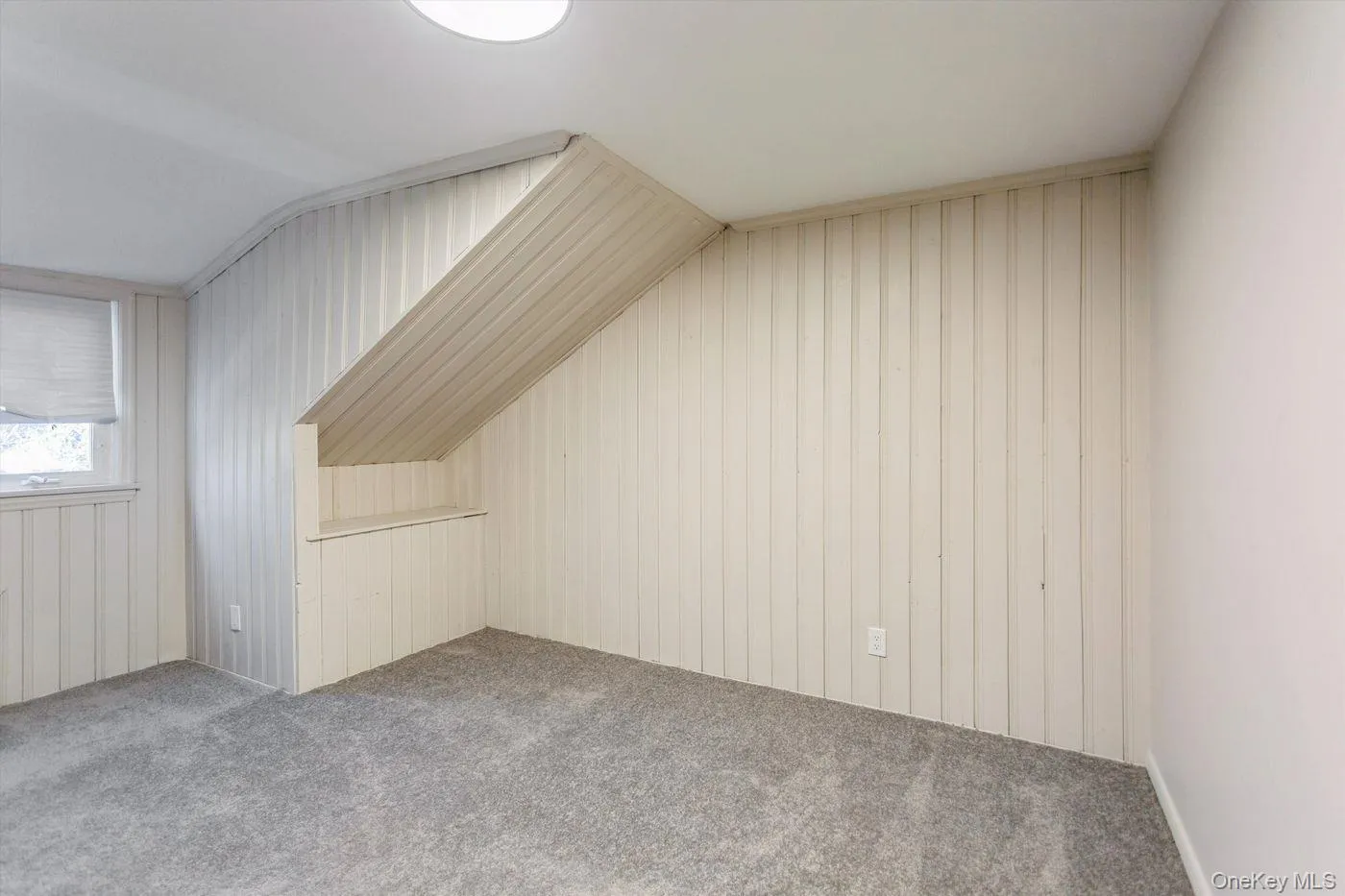 Additional living space featuring wood walls, carpet flooring, and lofted ceiling Additional living space featuring wood walls, carpet flooring, and lofted ceiling