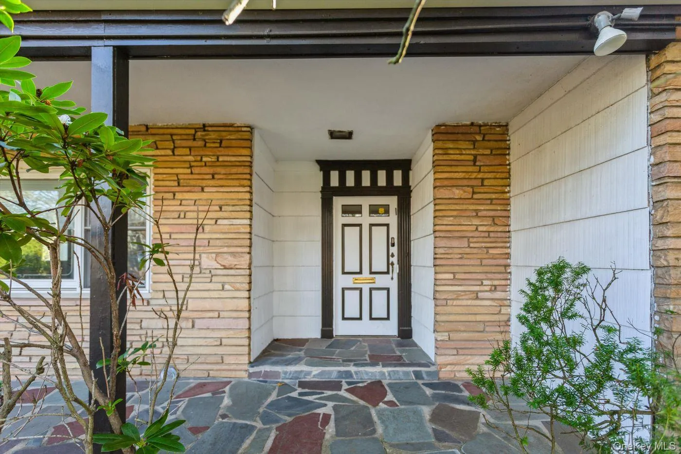 Entrance to property with brick siding and a porch Entrance to property with brick siding and a porch