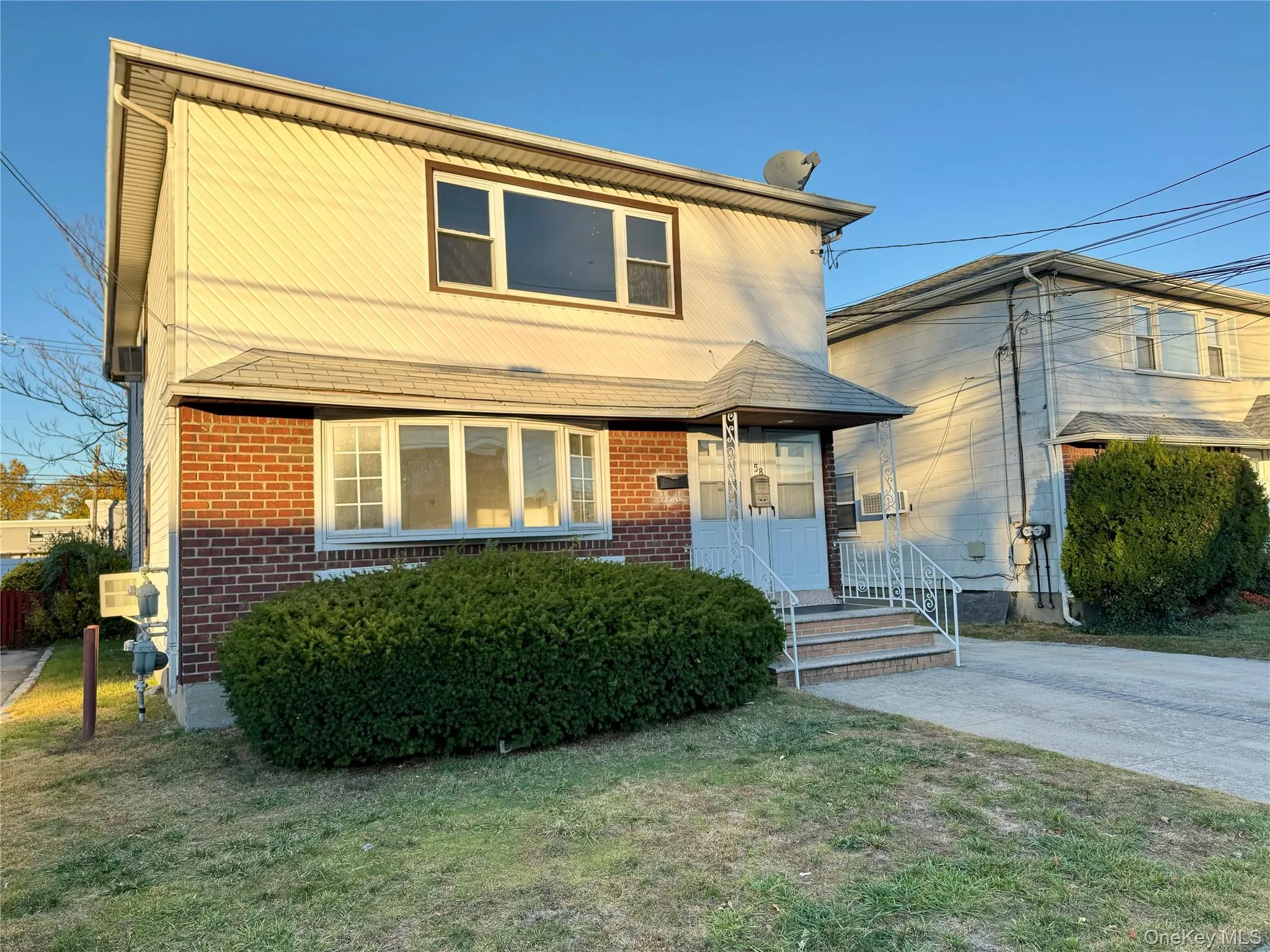 Traditional-style home with brick siding and a front lawn Traditional-style home with brick siding and a front lawn