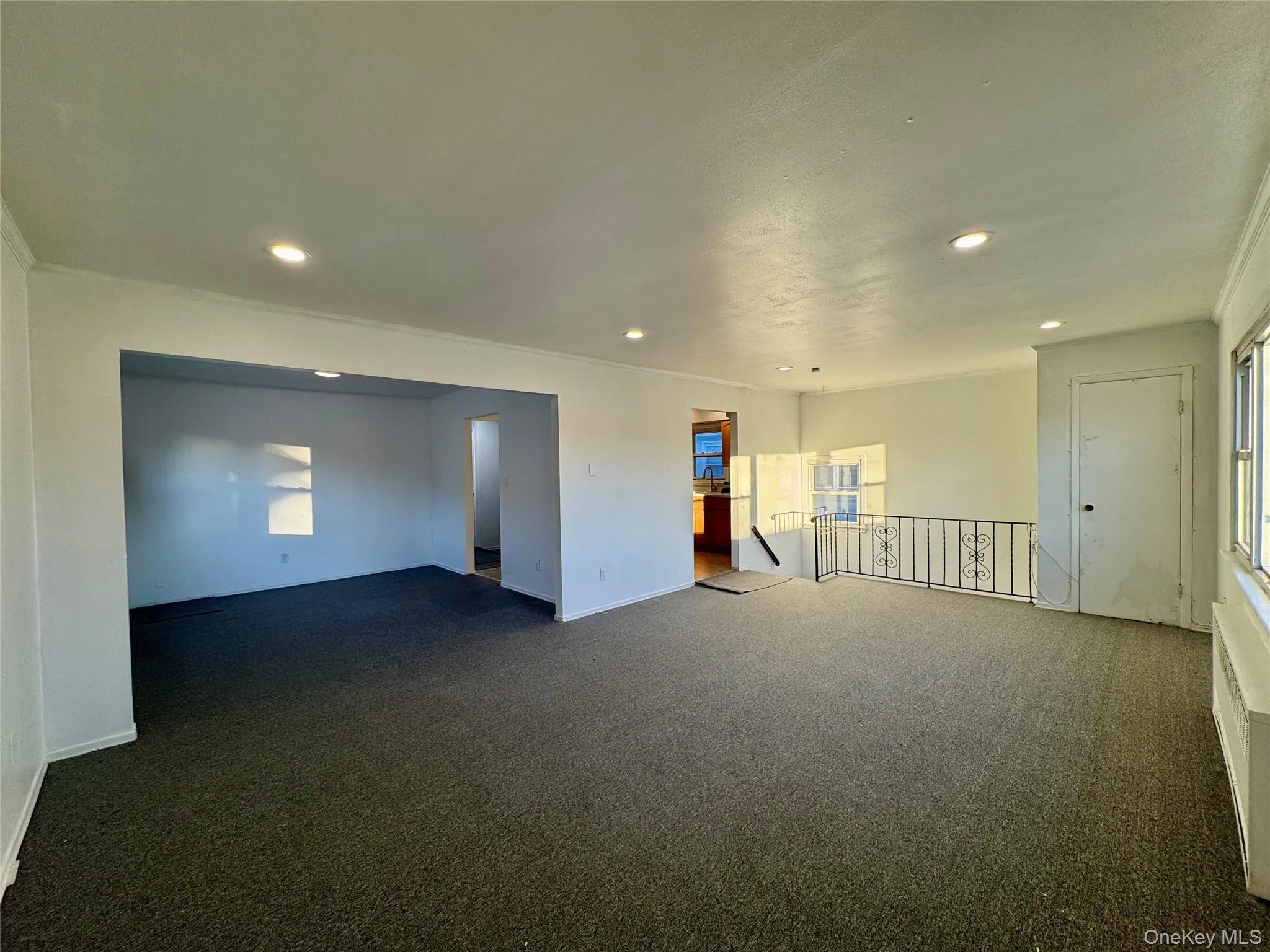Carpeted empty room featuring recessed lighting and crown molding Carpeted empty room featuring recessed lighting and crown molding