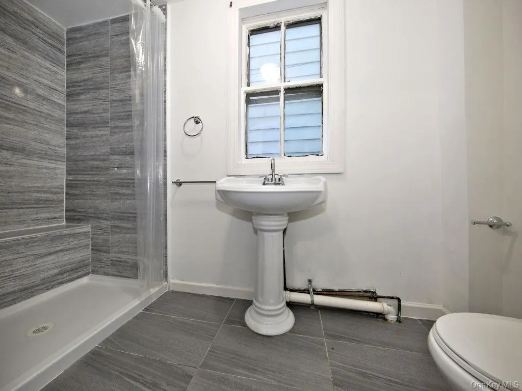 Bathroom with a stall shower and toilet Bathroom with a stall shower and toilet