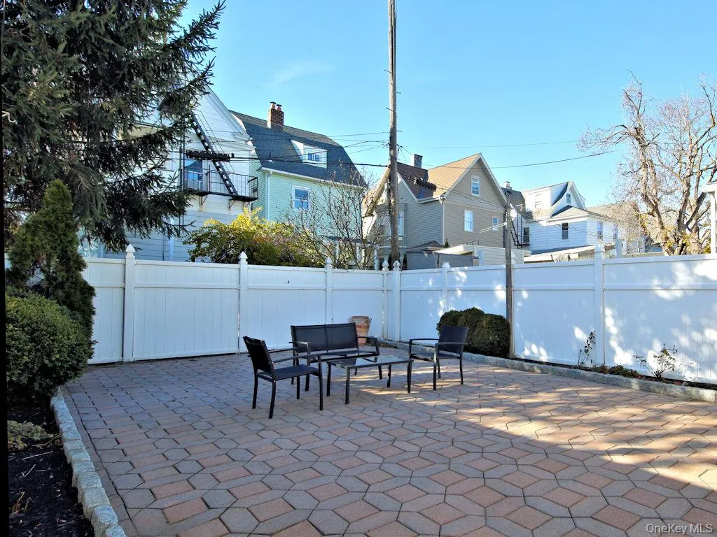 Fenced backyard with a patio and a residential view Fenced backyard with a patio and a residential view