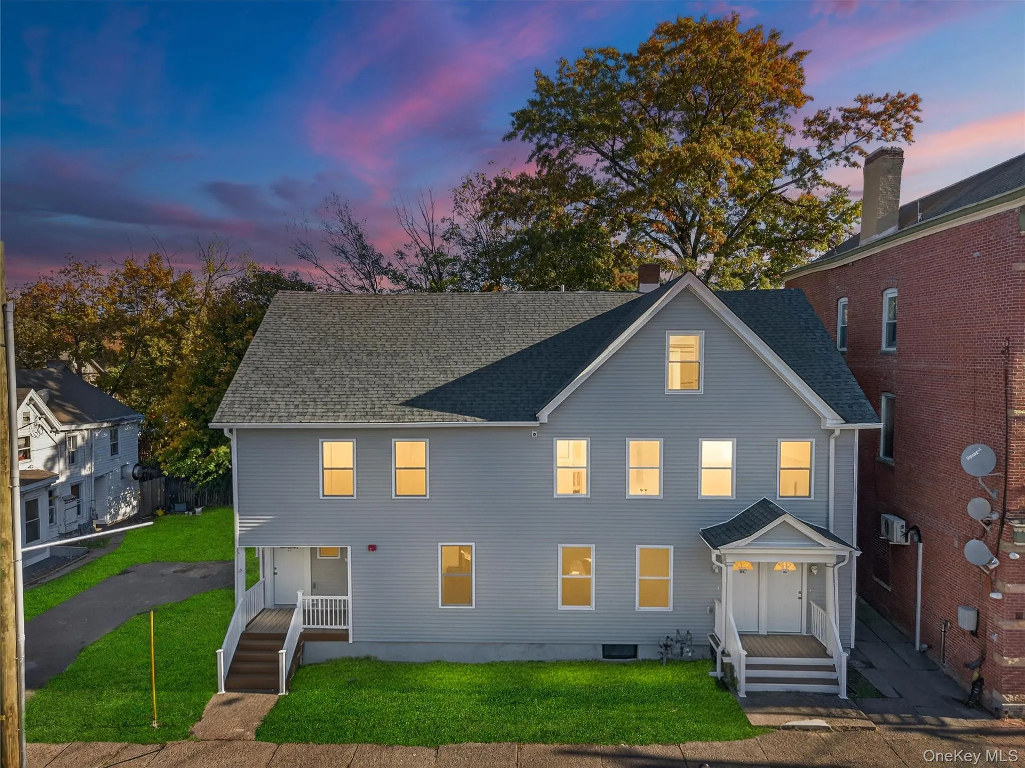 View of front of property featuring a front yard and roof with shingles View of front of property featuring a front yard and roof with shingles