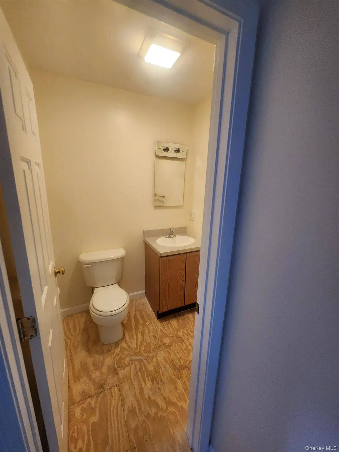 Half bath featuring vanity and toilet. Half bath featuring vanity and toilet.