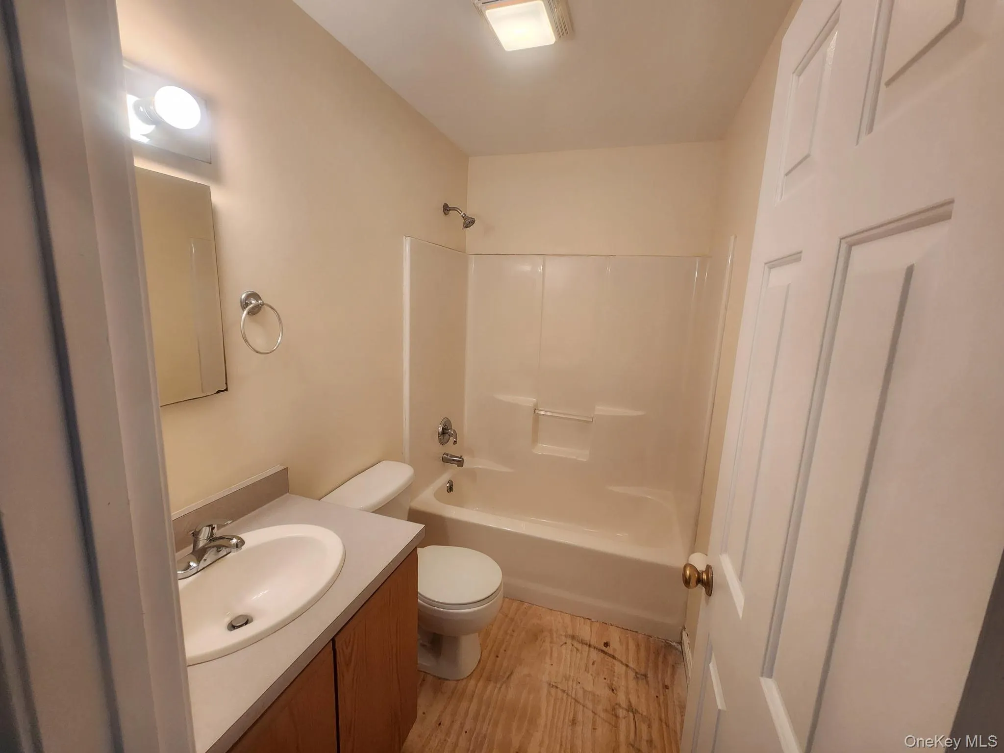 Full bathroom with light wood-style floors, vanity, and shower / bath combination. Full bathroom with light wood-style floors, vanity, and shower / bath combination.