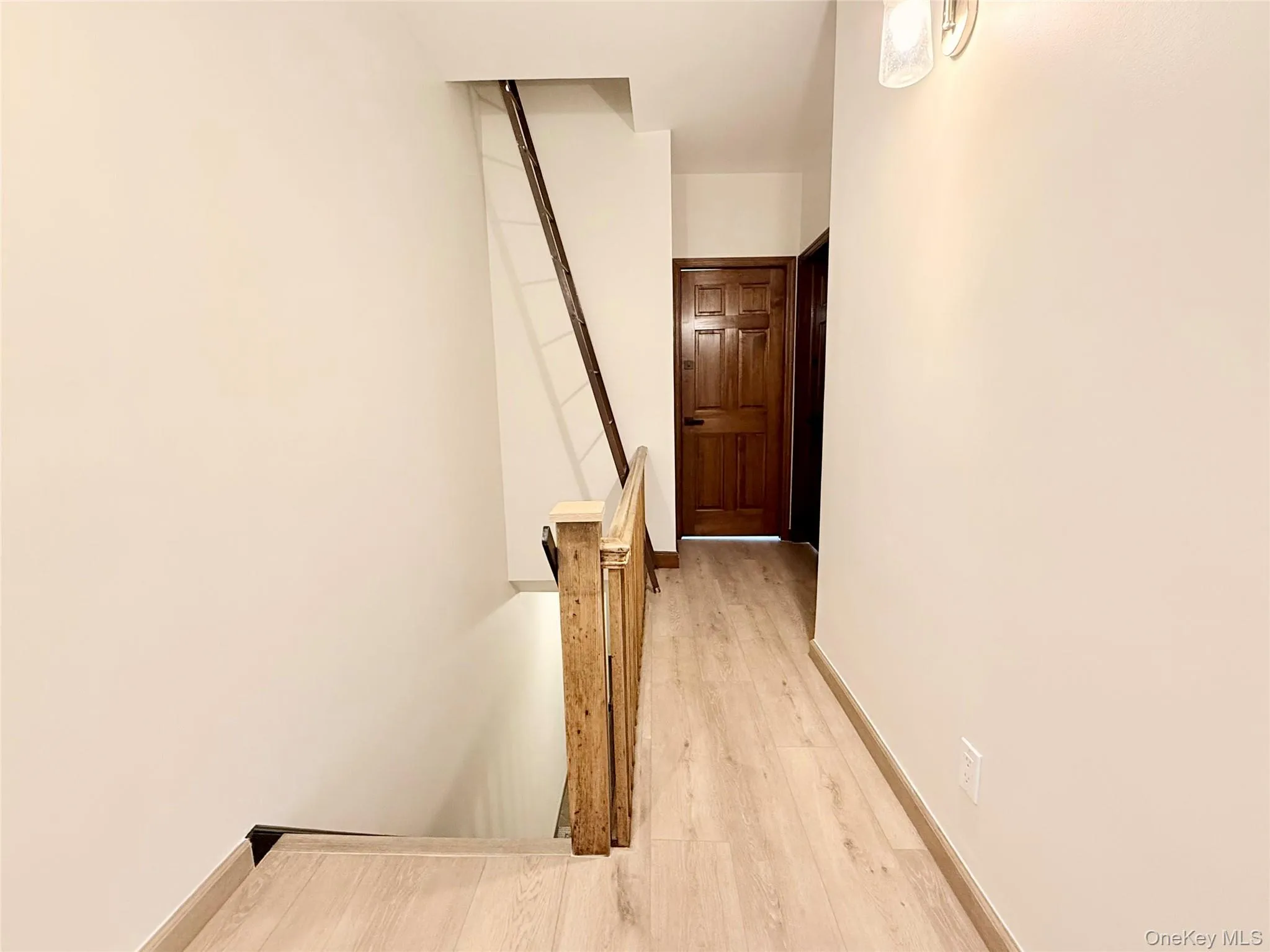 Stairway featuring wood finished floors and baseboards Stairway featuring wood finished floors and baseboards
