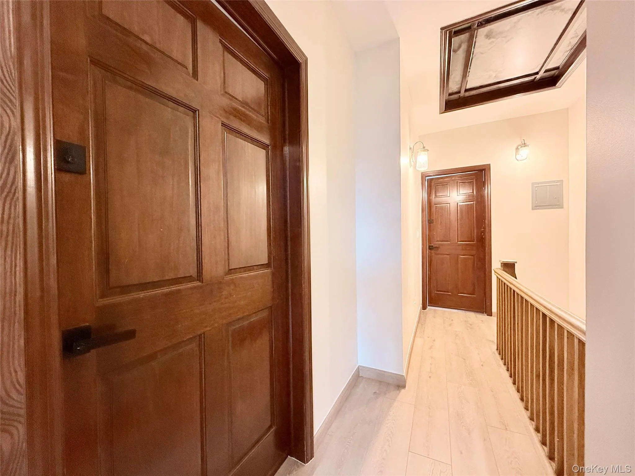 Corridor with light wood finished floors and baseboards Corridor with light wood finished floors and baseboards