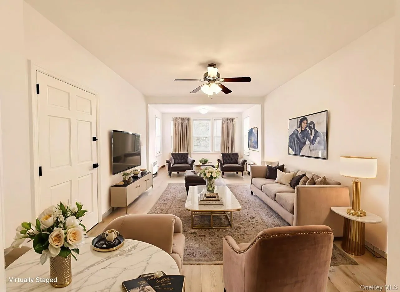 Living area with light wood-type flooring and a ceiling fan Living area with light wood-type flooring and a ceiling fan