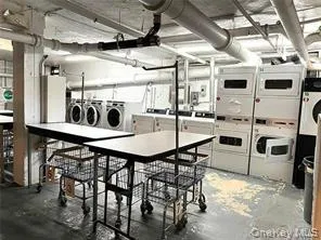 Community laundry room featuring separate washer and dryer and stacked washer / drying machine Community laundry room featuring separate washer and dryer and stacked washer / drying machine