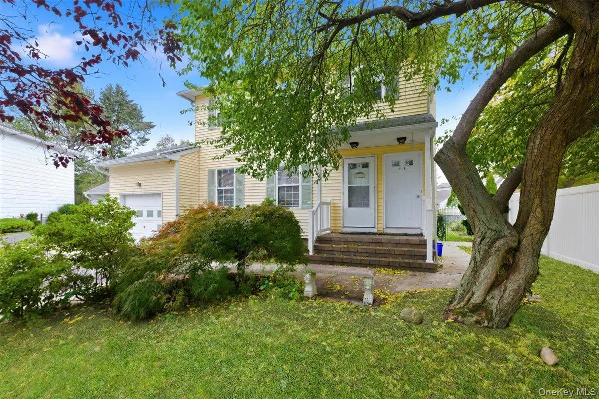 Obstructed view of property featuring an attached garage Obstructed view of property featuring an attached garage