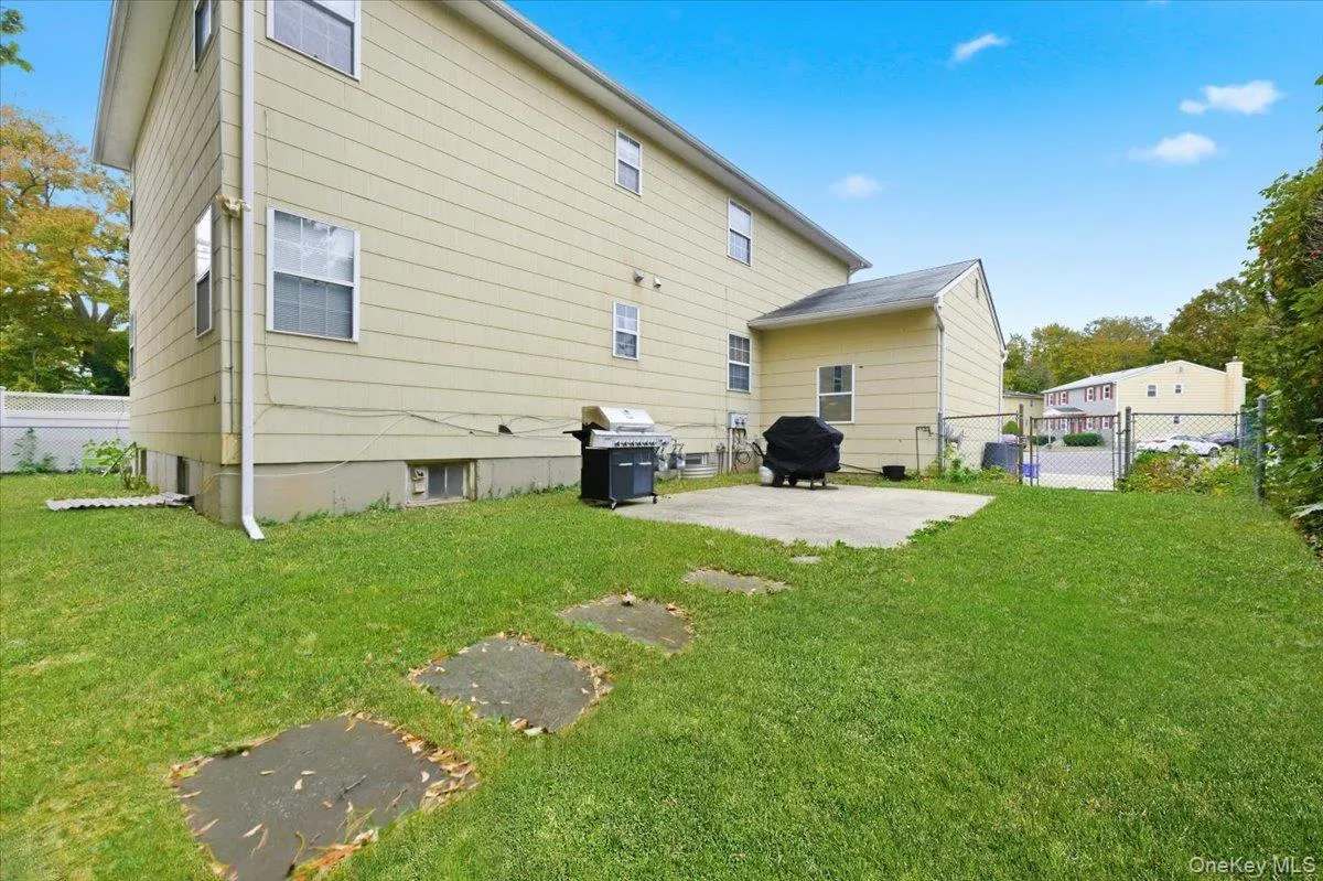 Rear view of property featuring a patio and a gate Rear view of property featuring a patio and a gate