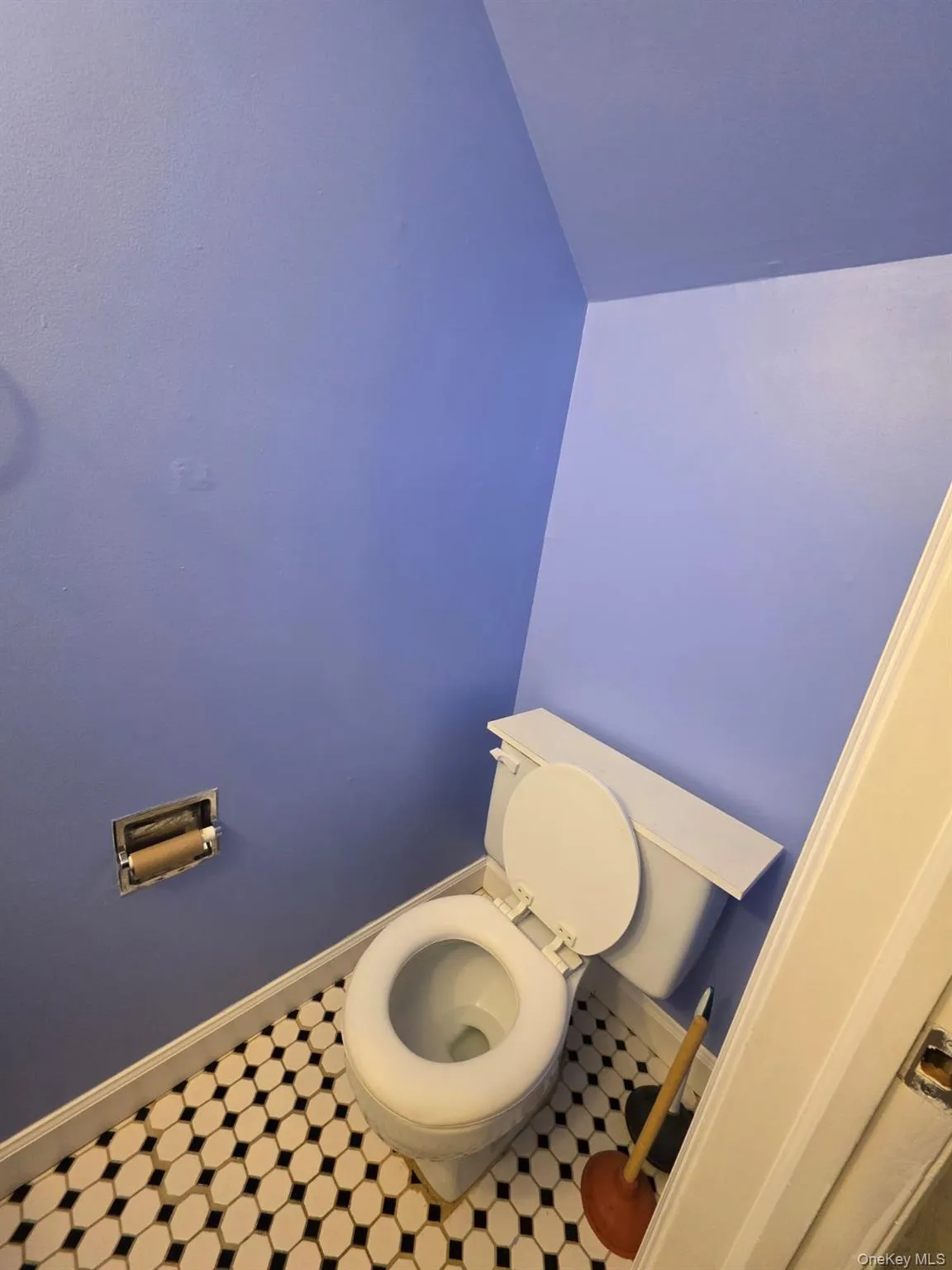 Bathroom featuring baseboards and toilet Bathroom featuring baseboards and toilet