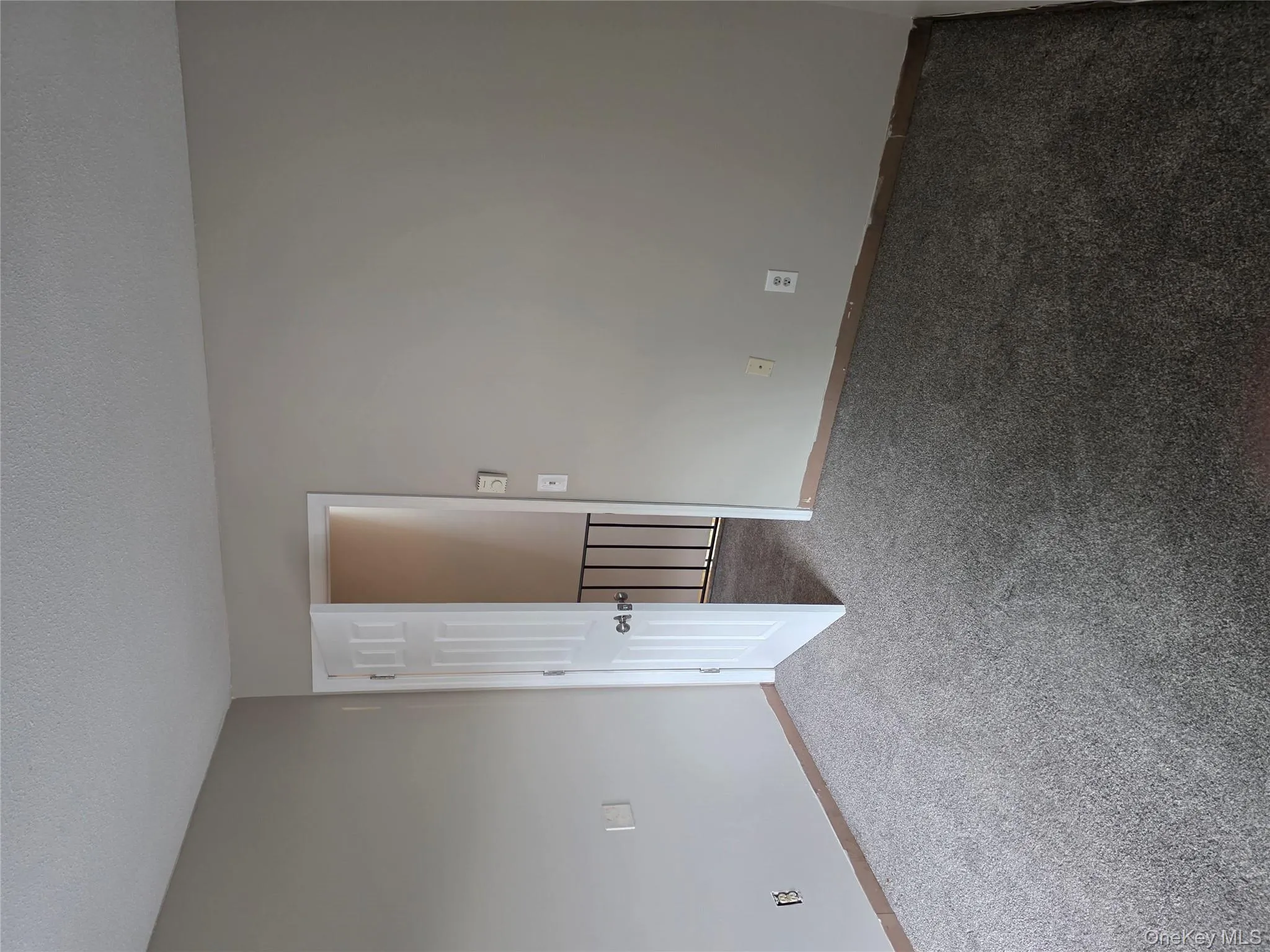 Empty room with carpet floors and a textured ceiling Empty room with carpet floors and a textured ceiling